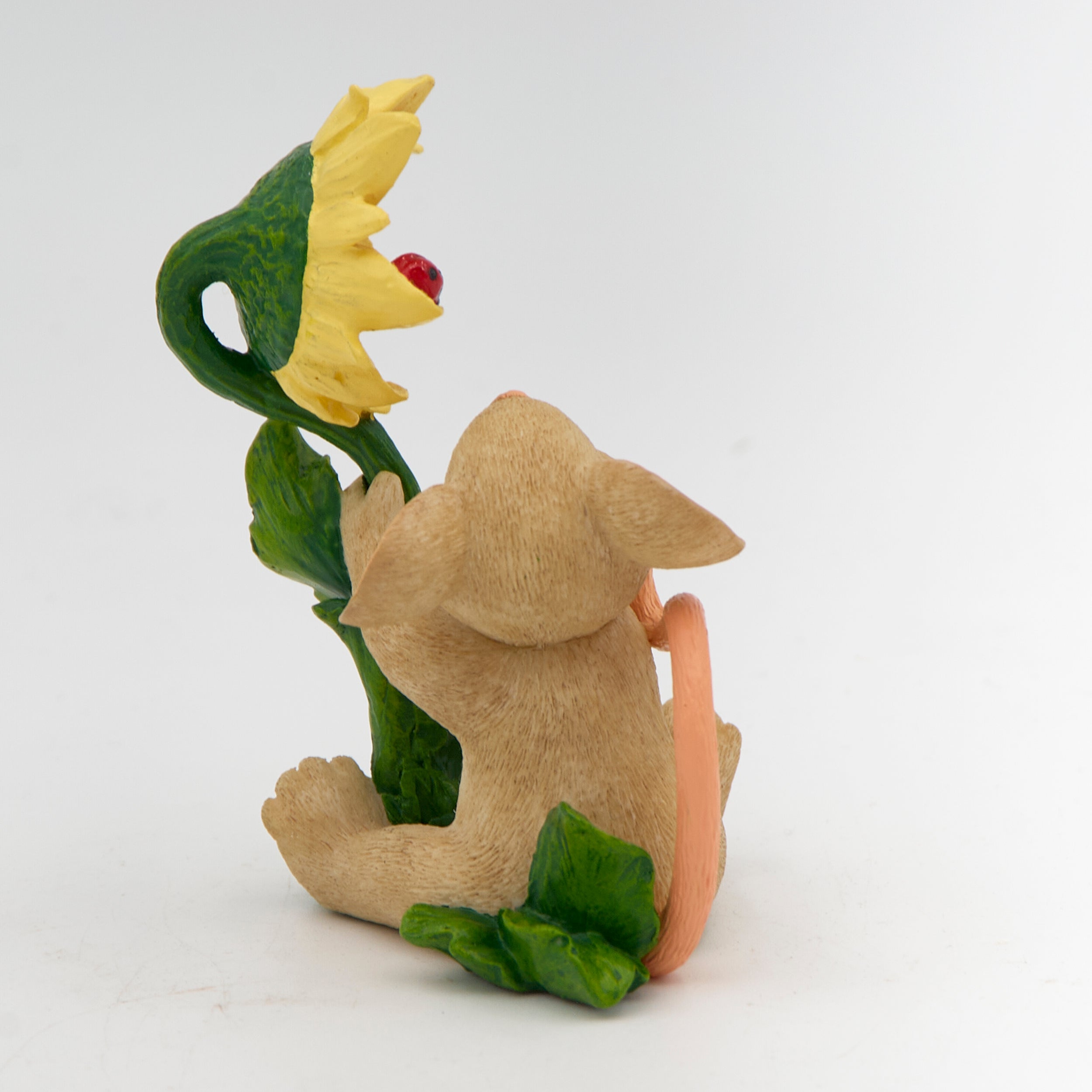 Mouse figurine with a sunflower on a white background