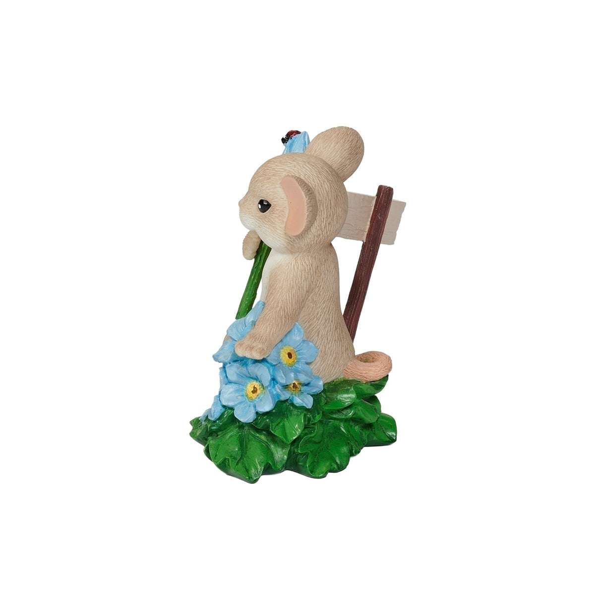 Side view of Charming Tails Forget Me Not figure showing the mouse holding a flower among blue forget-me-nots