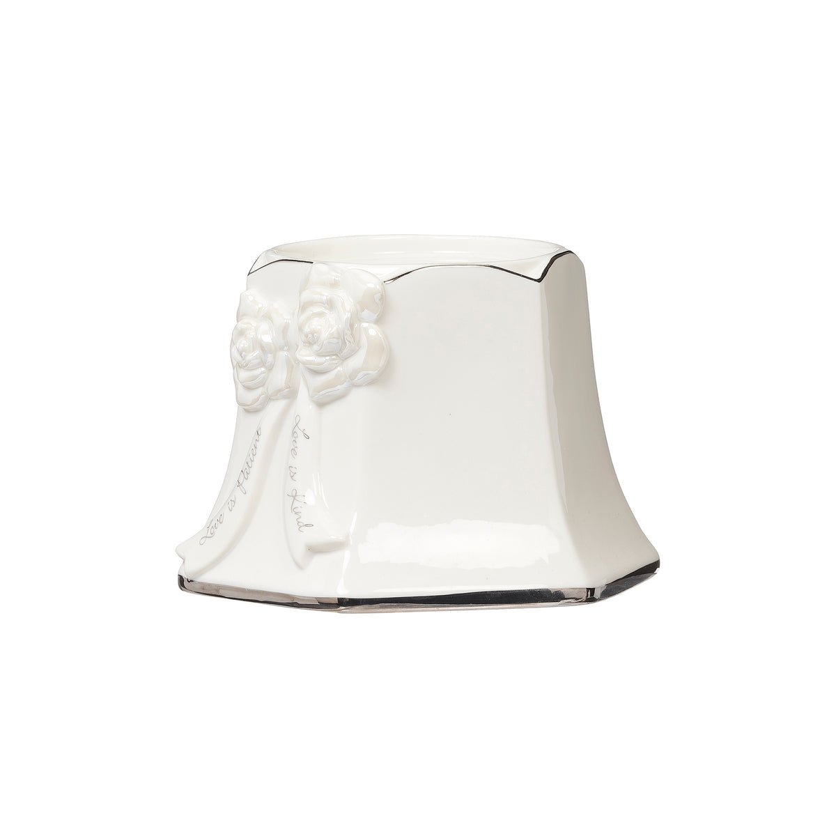 Angled view of the white porcelain pillar holder showing floral detailing and a flared base.