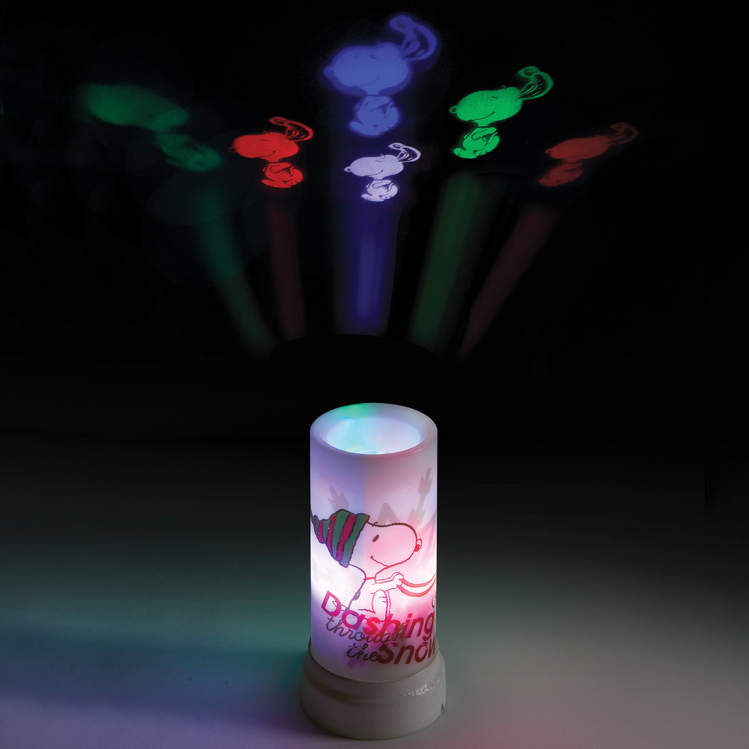 White cylindrical device with colorful light projections on a dark background featuring snoopy