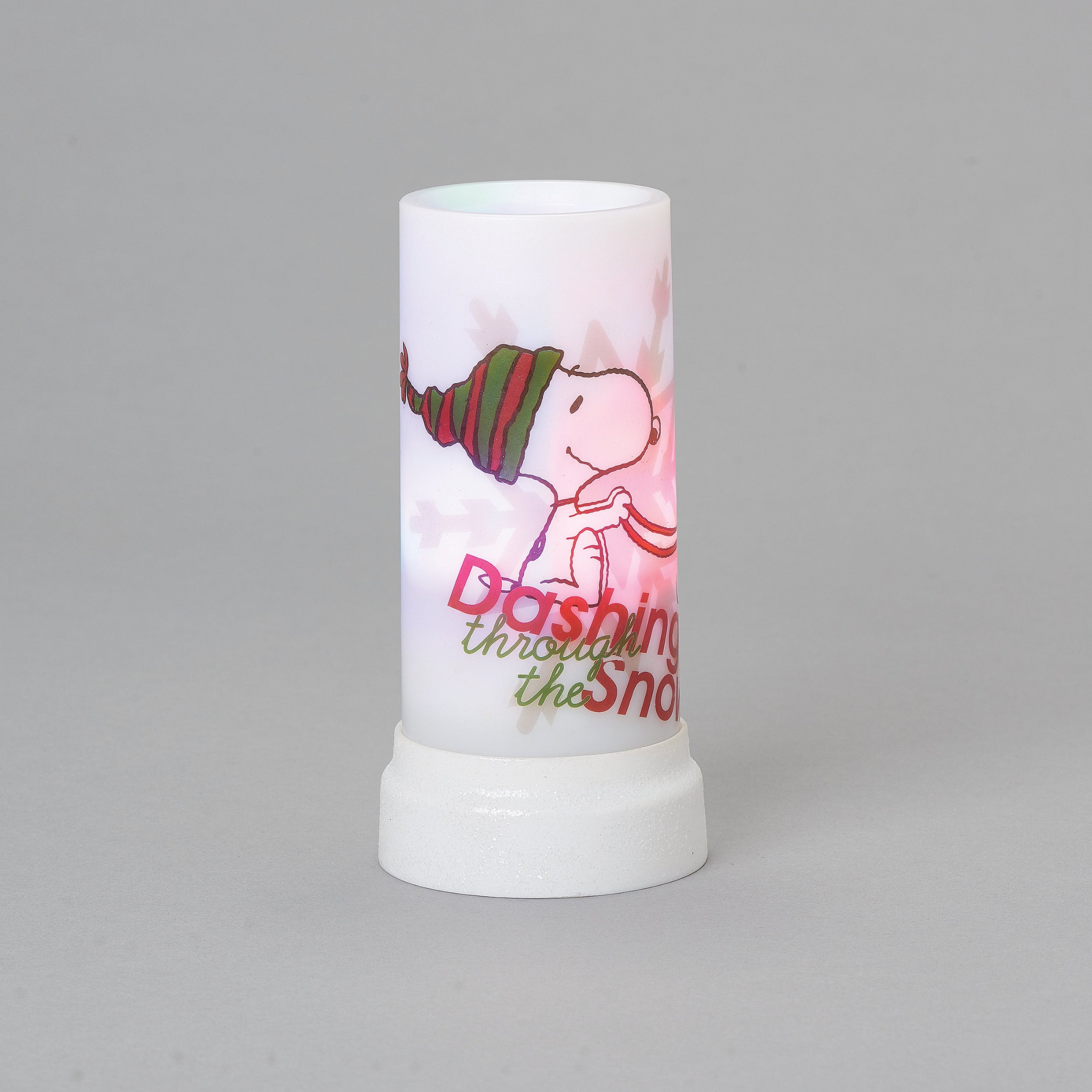 Decorative candle with a cartoon character and text on a gray background