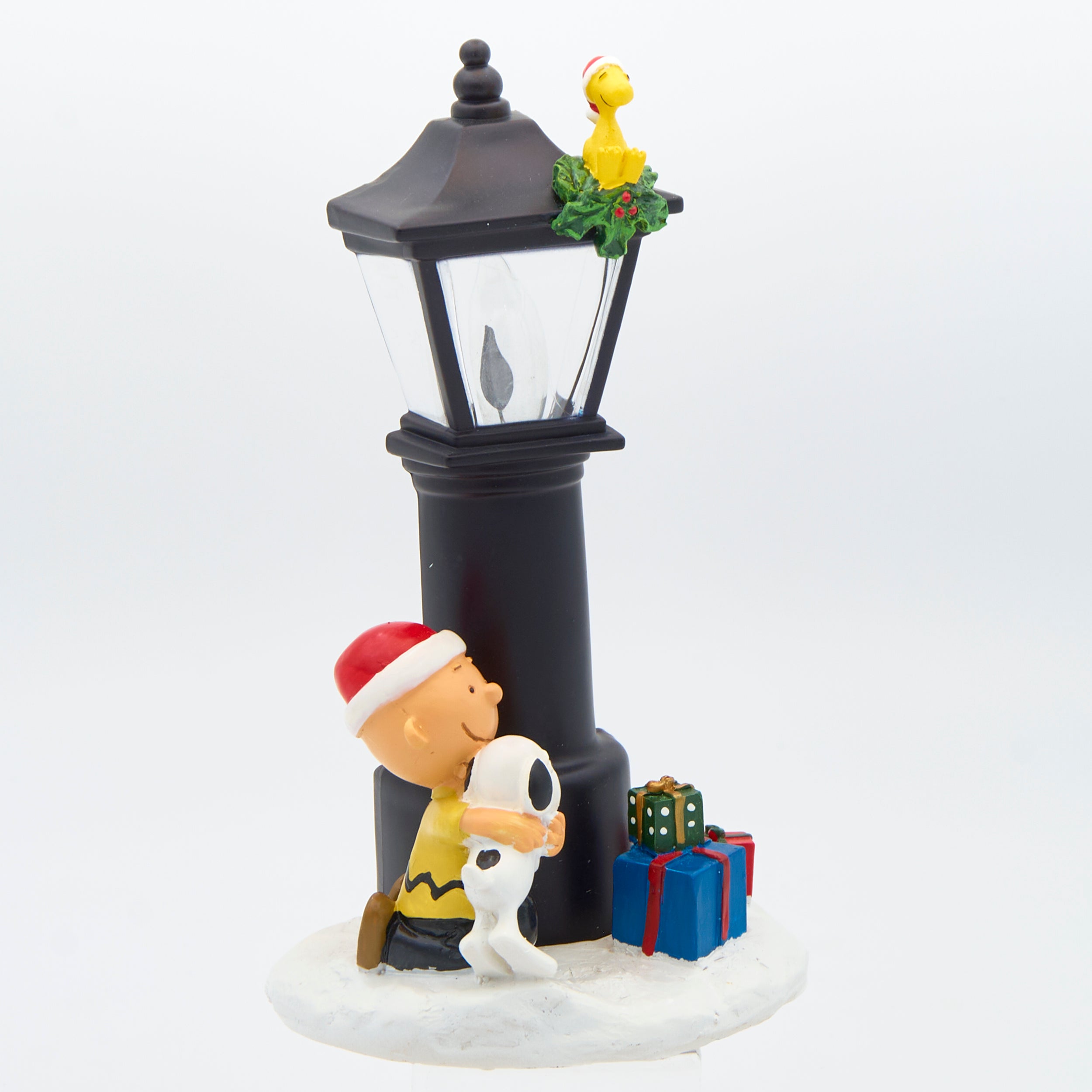 Decorative figure with Charlie Brown, Snoopy, and a lamp post with presents