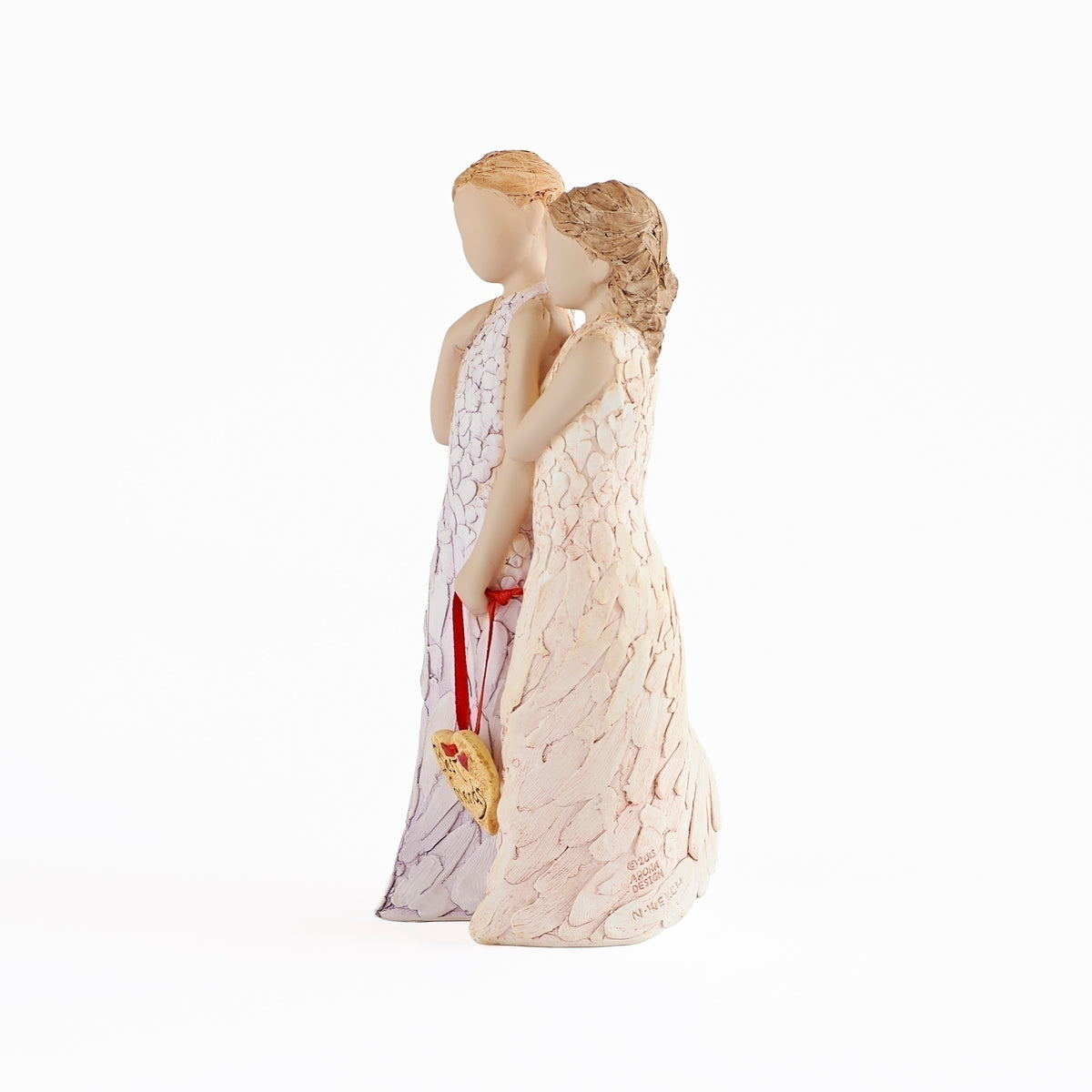 Front angled view of Best Friends figure showing two women standing close together in softly patterned dresses