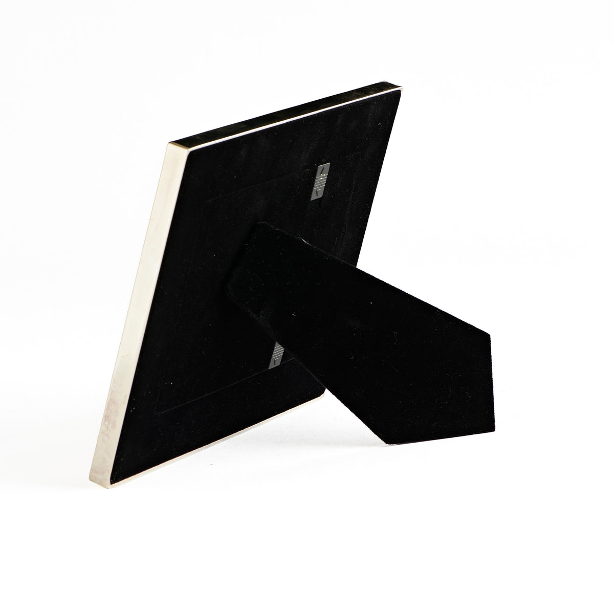 Rear angled view of Caroline Collection Silver Cross Picture Frame showing the black backing and tabletop easel stand
