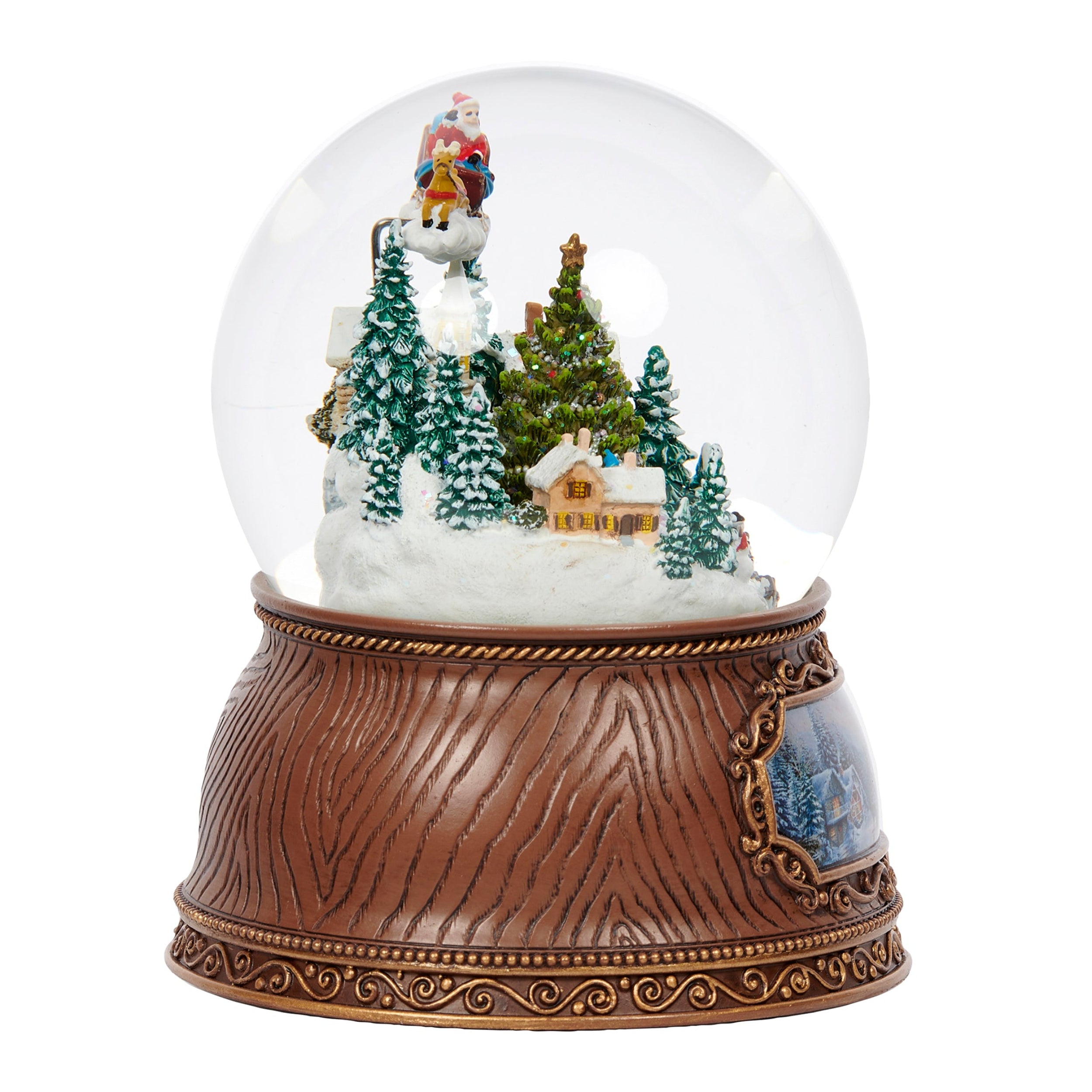 Snow globe with Santa Claus and reindeer on a snowy landscape with trees and a house.