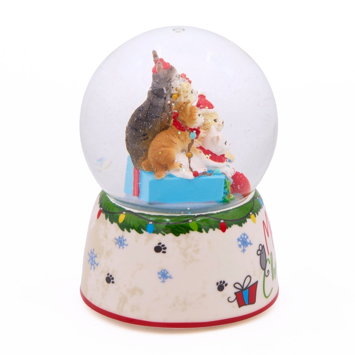 Side view of Meowy Christmas snow globe showing stacked cats, presents, and a cream base decorated with colorful lights and snowflakes.