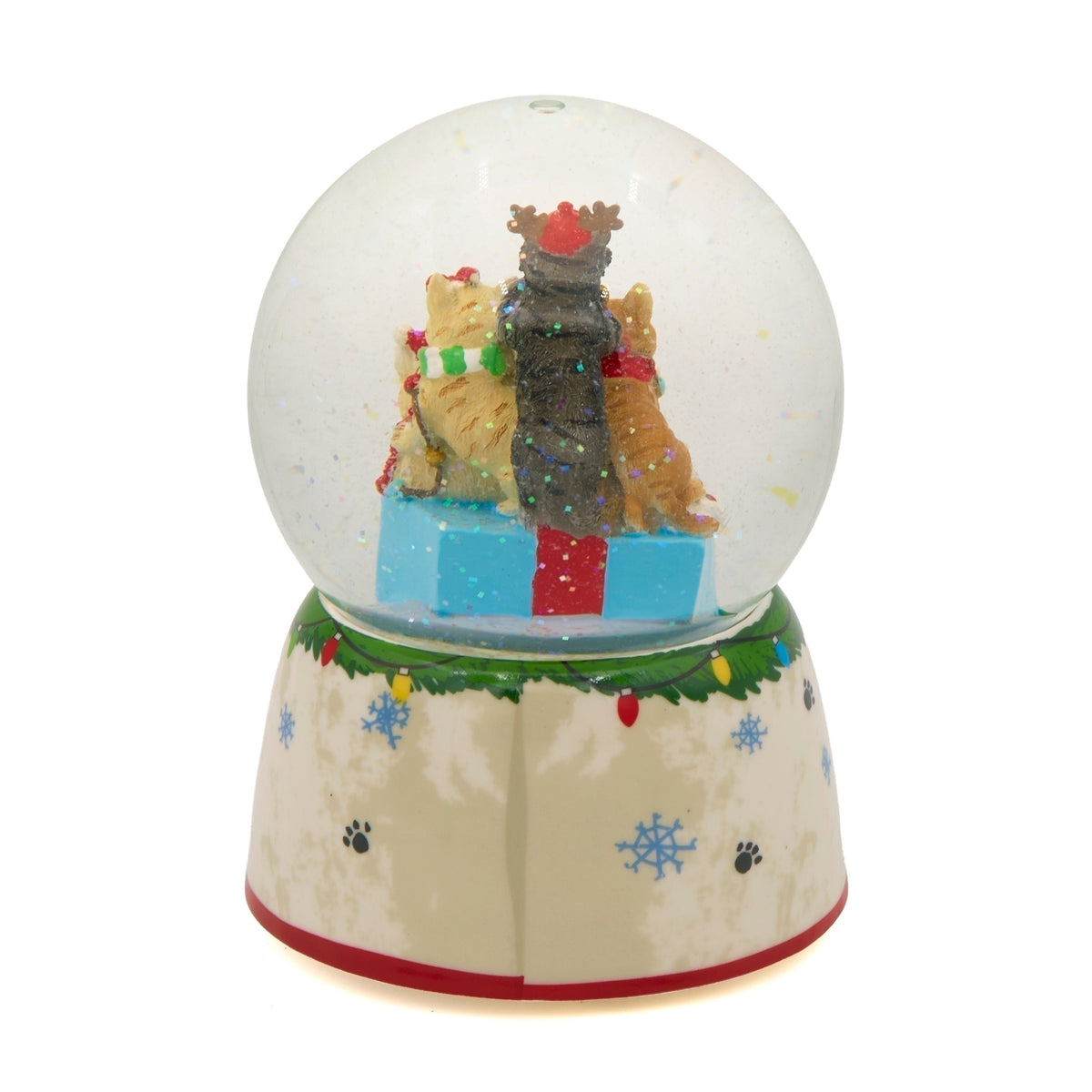 Rear view of Meowy Christmas snow globe showing the backs of the stacked cats and a base trimmed with green garland and red edging.