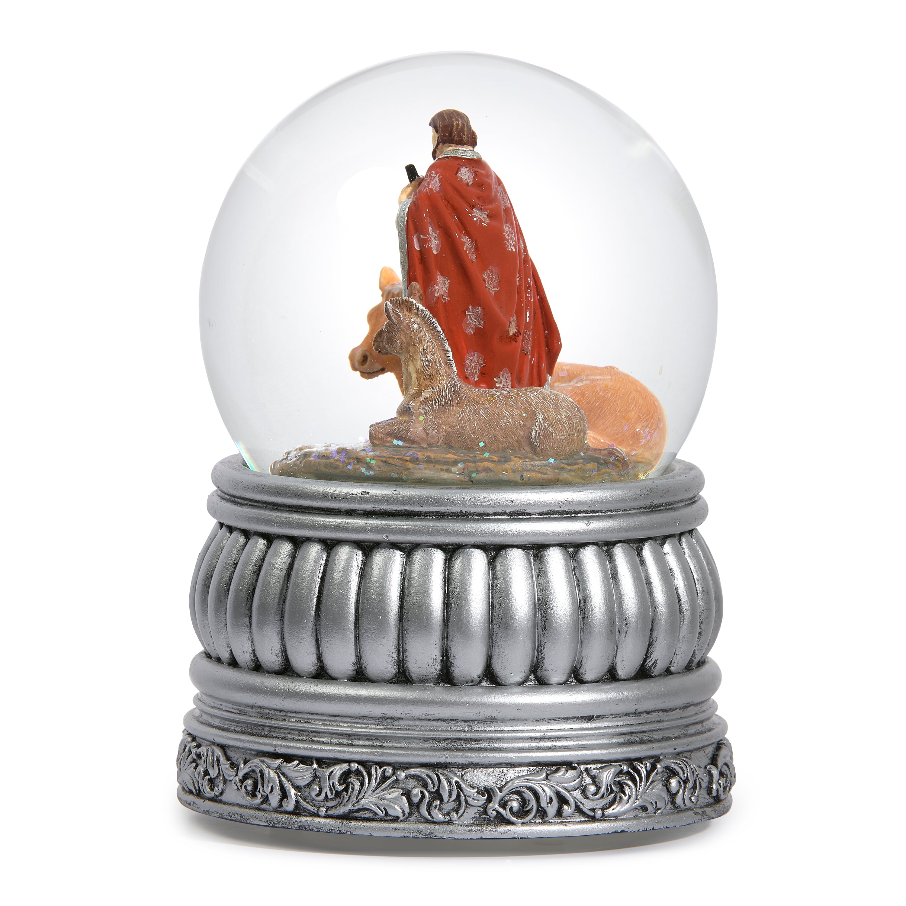 Decorative snow globe with nativity scene figures inside on a white background