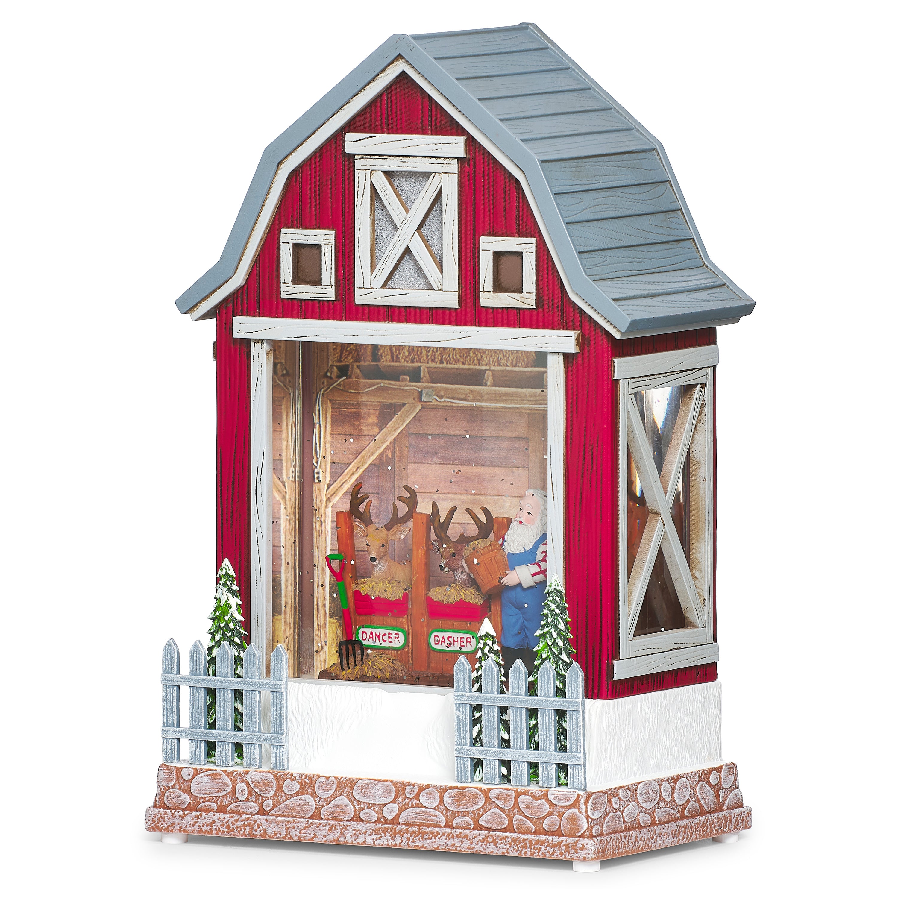 Decorative model of a red barn with a country Santa and reindeer inside on a white background