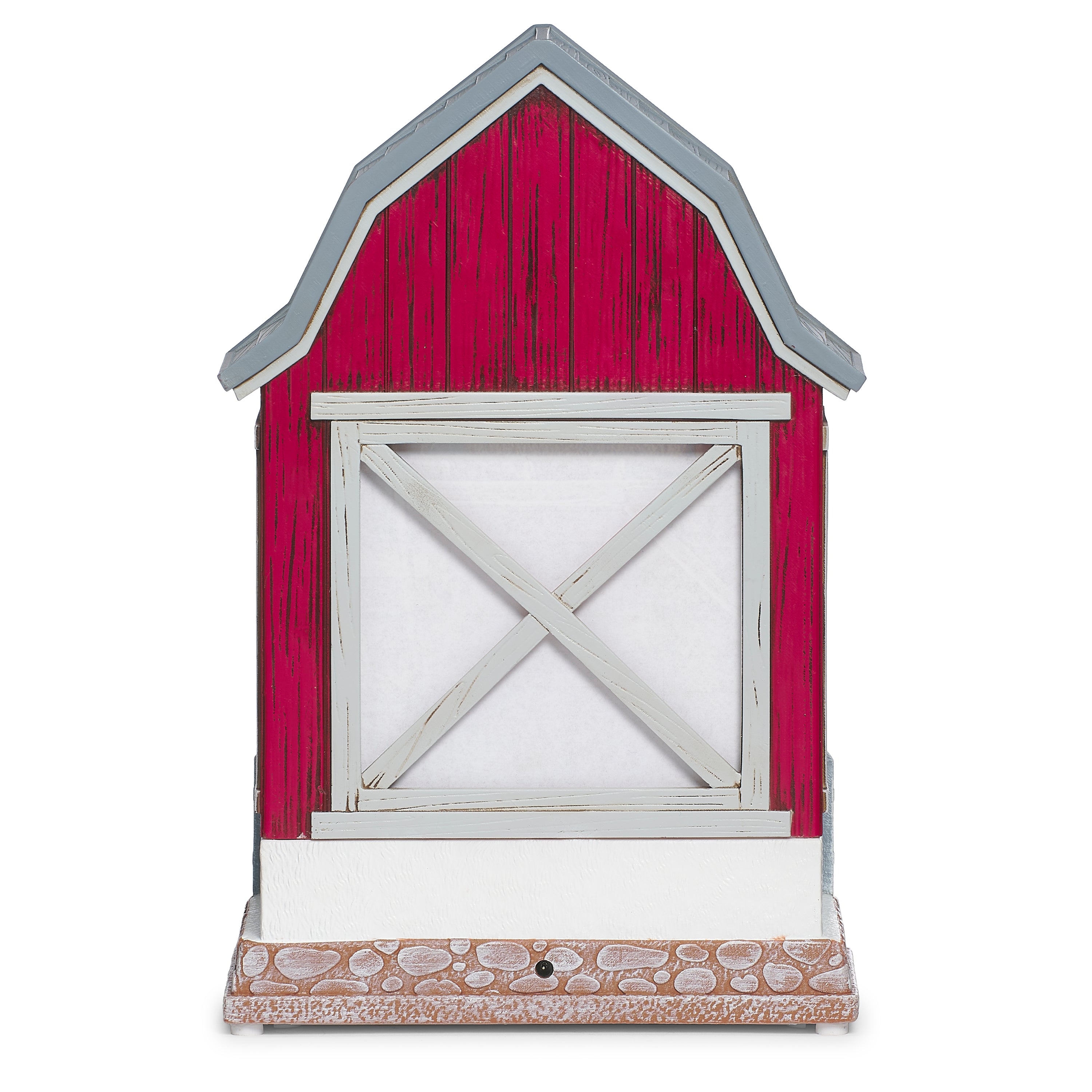 Decorative model of a red barn with a country Santa and reindeer inside on a white background