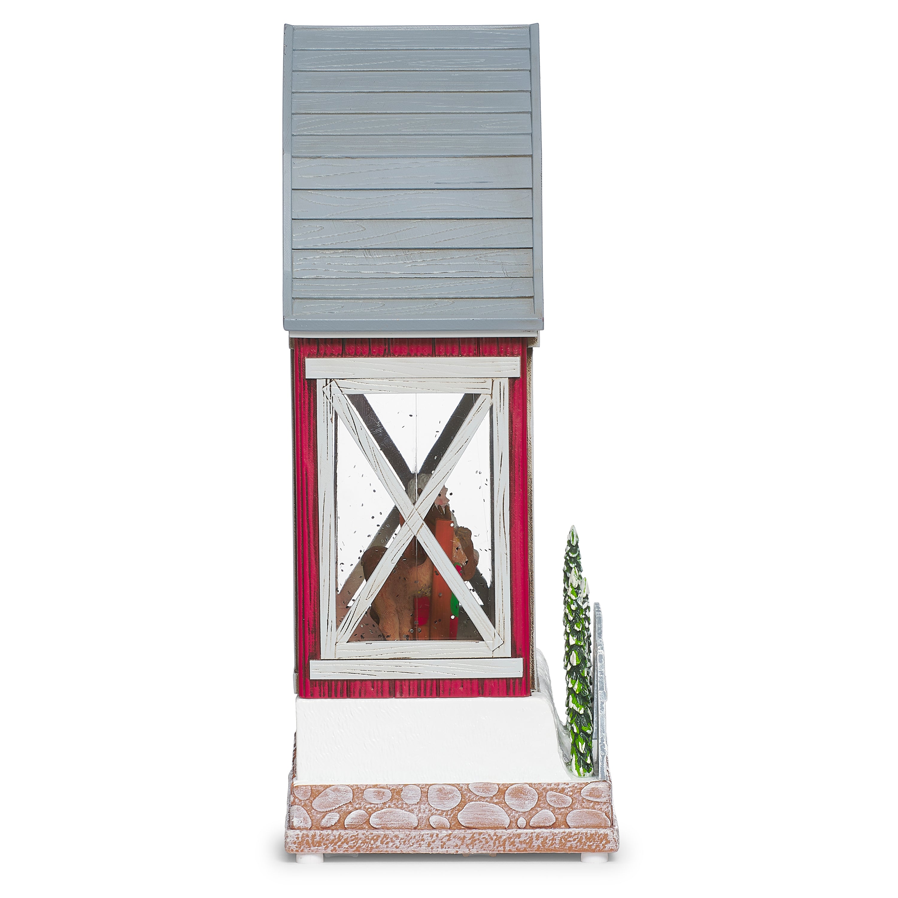 Decorative model of a red barn with a country Santa and reindeer inside on a white background