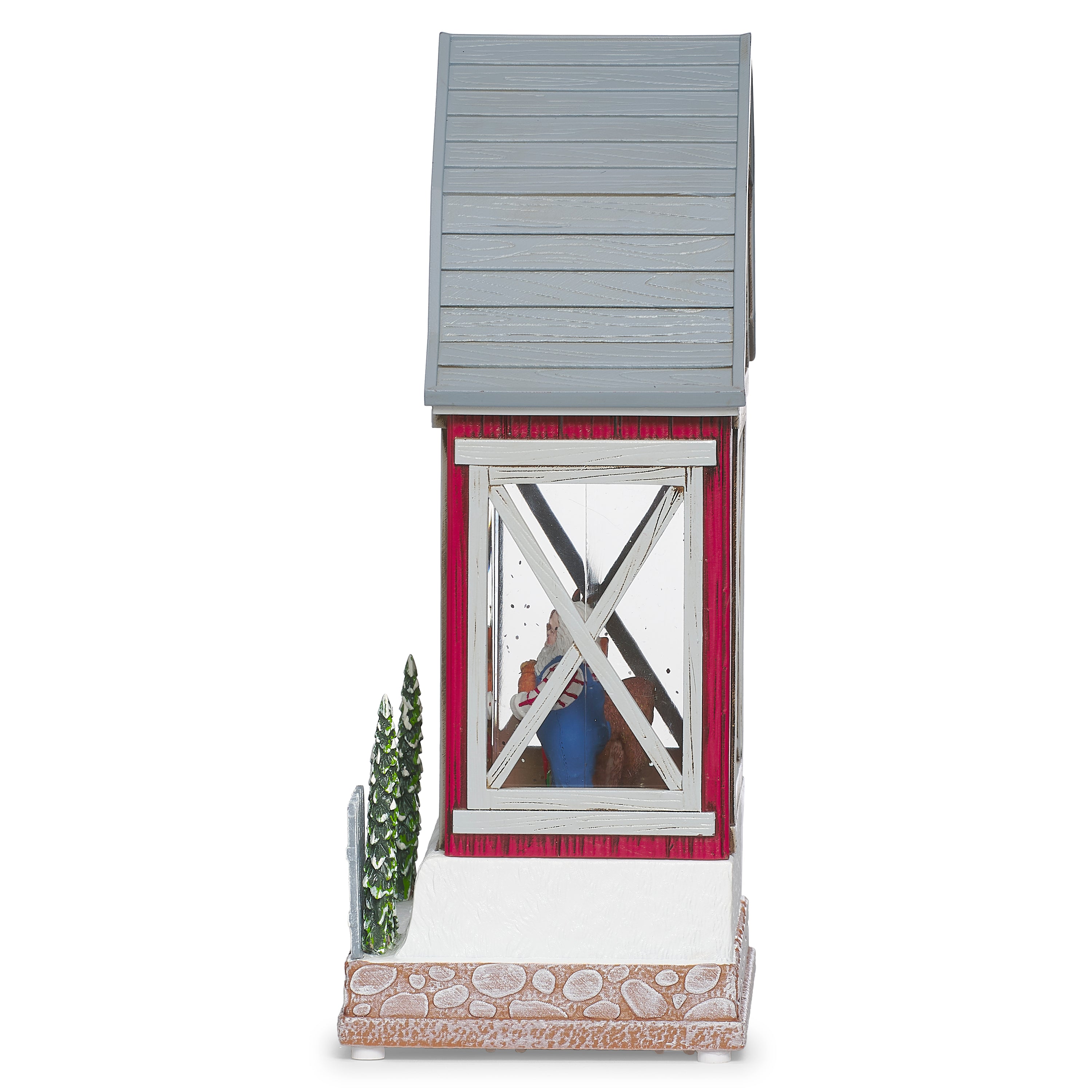 Decorative model of a red barn with a country Santa and reindeer inside on a white background