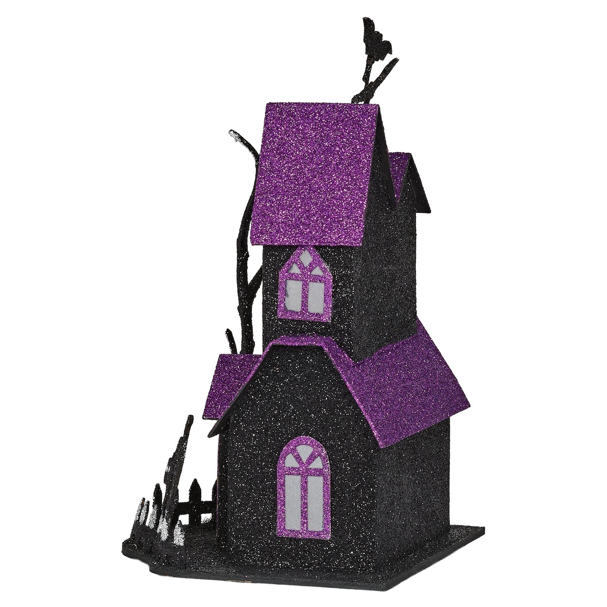 Angled view of haunted house showing purple glitter roofs, arched windows, and a bare tree beside the entrance.