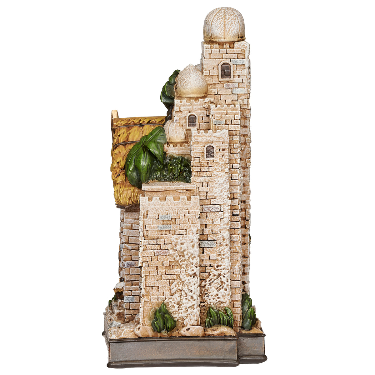 Side view: Side view of Lighted Nativity in Town Scene showing the layered village architecture, stone-look walls, and sculpted greenery