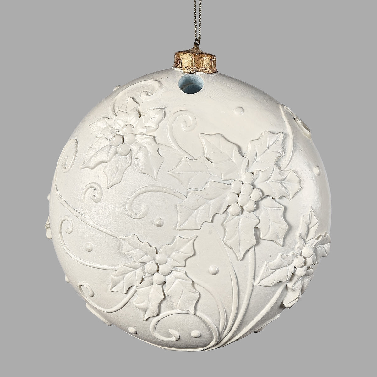 Back view of carved white deer Christmas ornament with raised botanical details