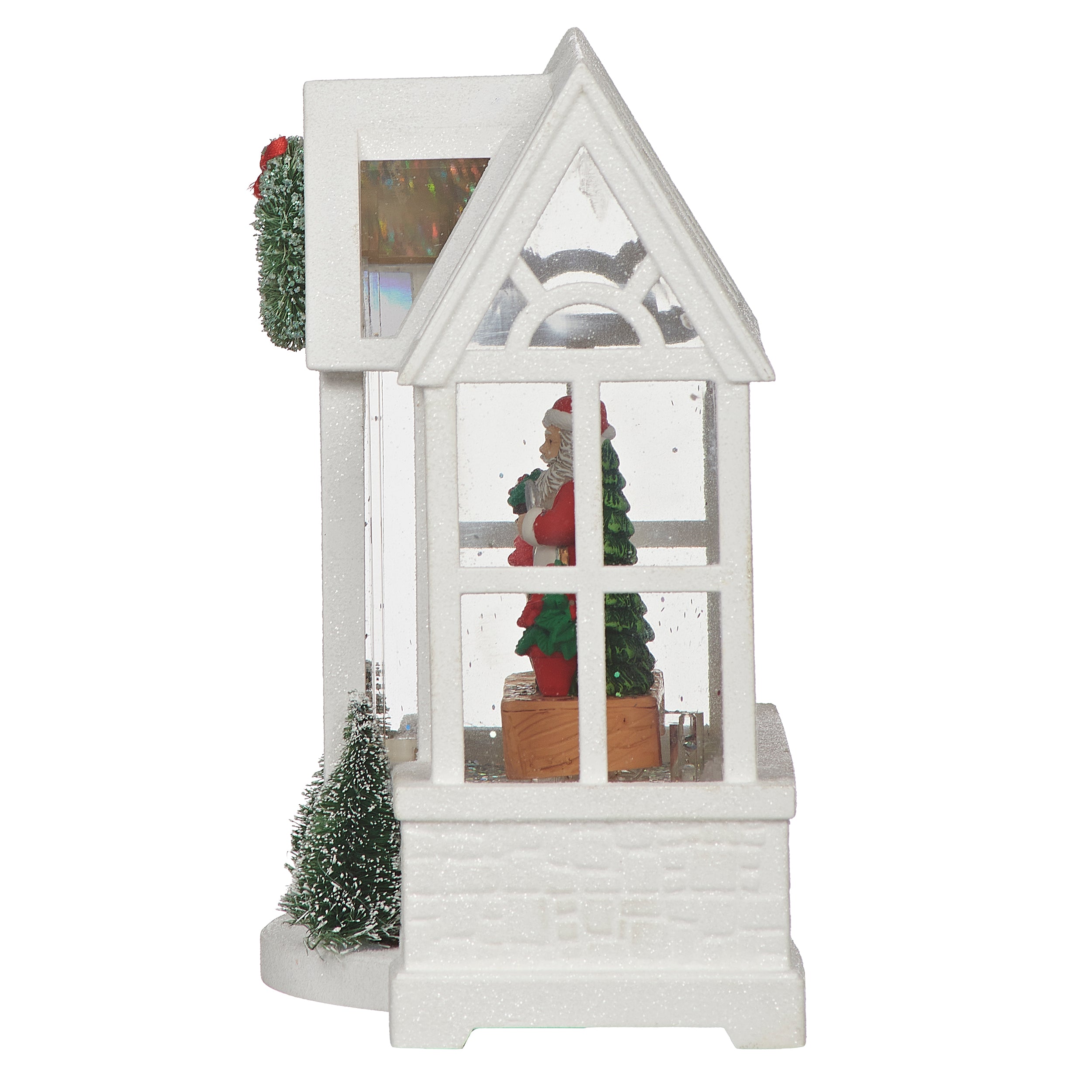 Decorative white house with Santa Claus figure and Christmas trees on a white background