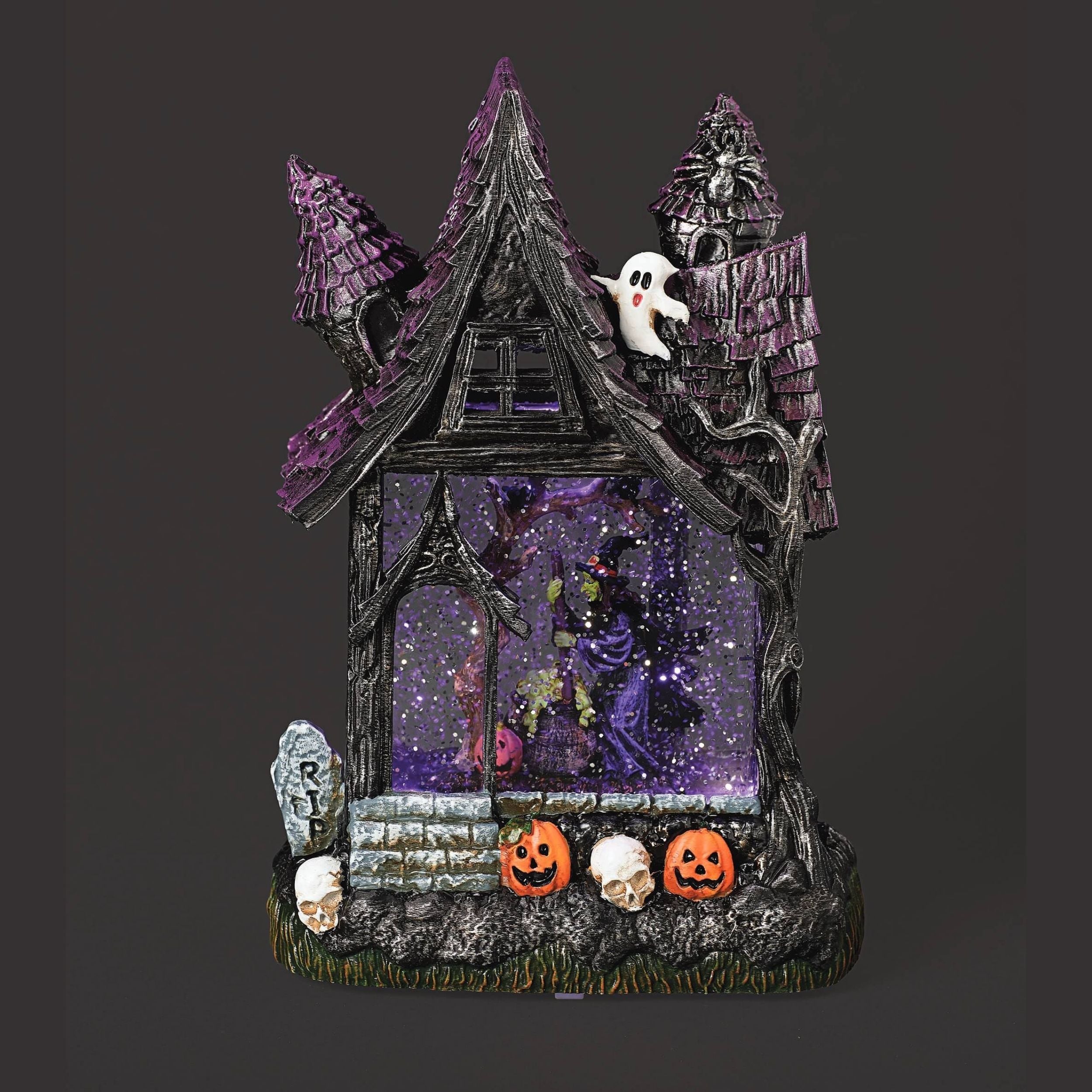 Haunted house with a witch inside with ghosts, pumpkins, and tombstones on a dark background