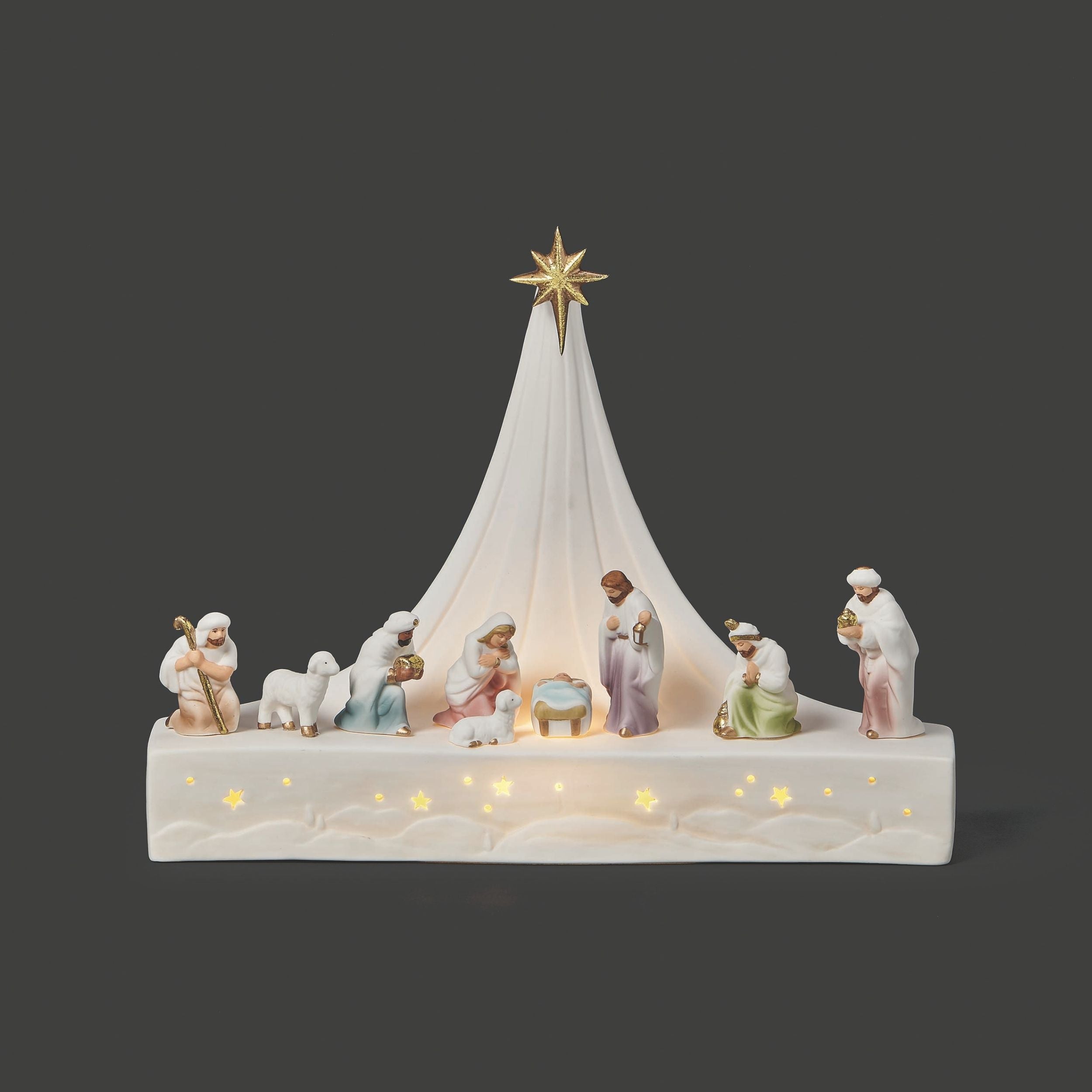 Nativity scene with illuminated base on a dark background