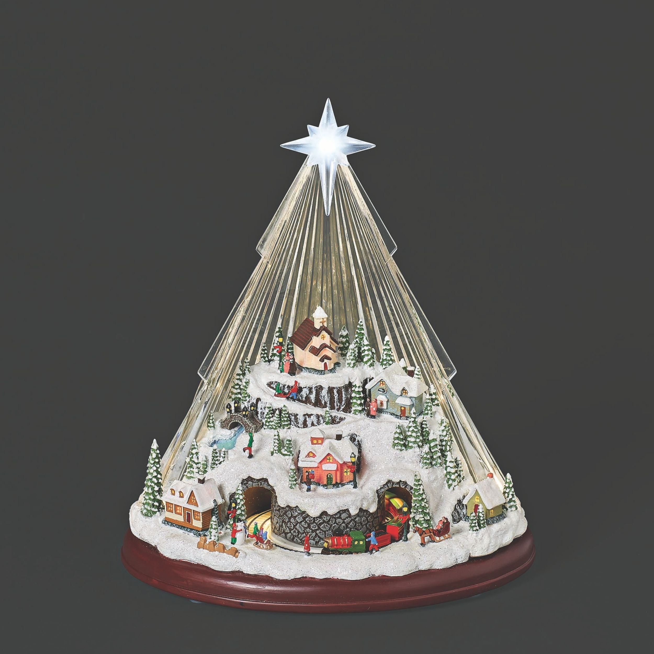 Decorative Christmas tree with lights and miniature village on a black background