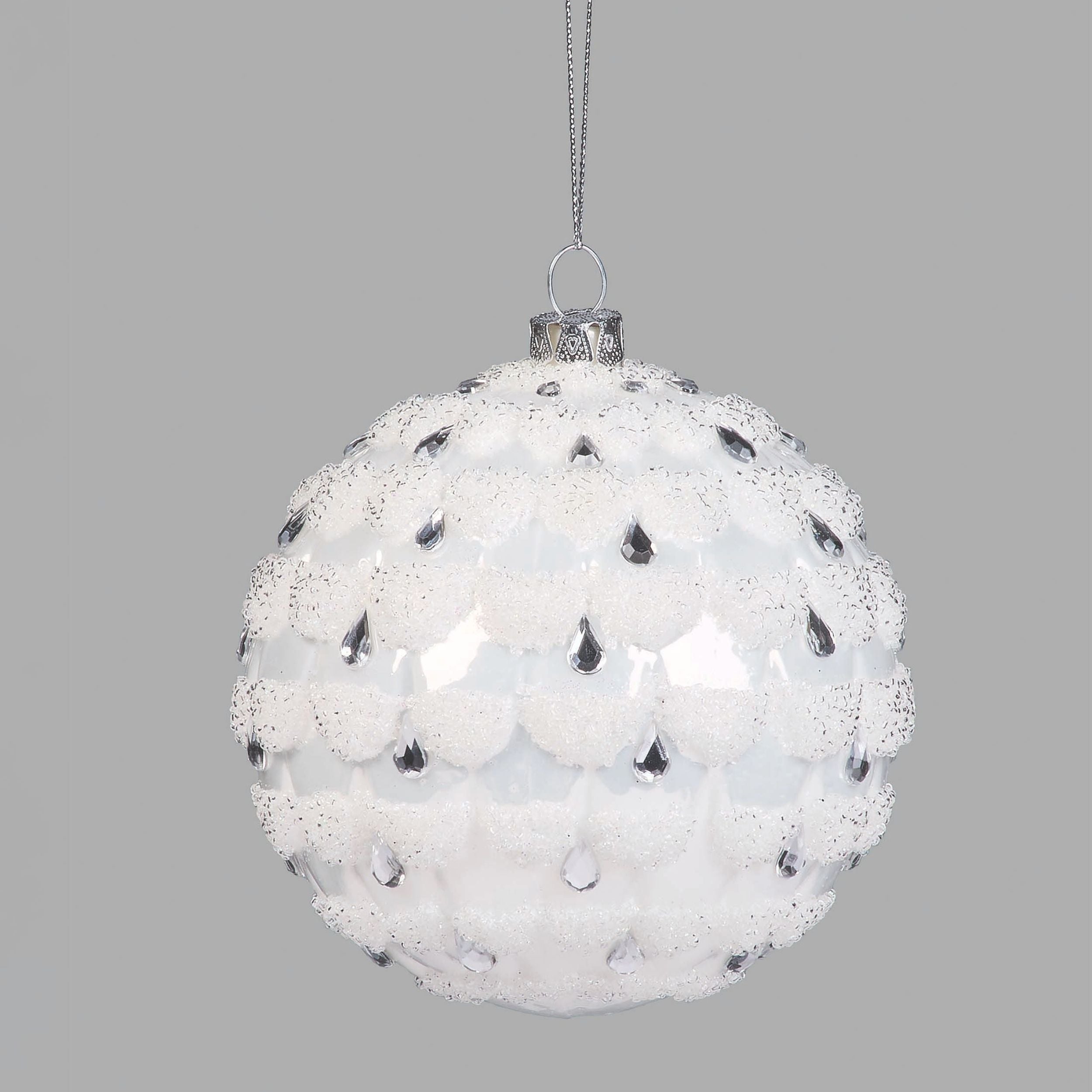 Decorative Christmas ball ornament with white and black pattern on a gray background