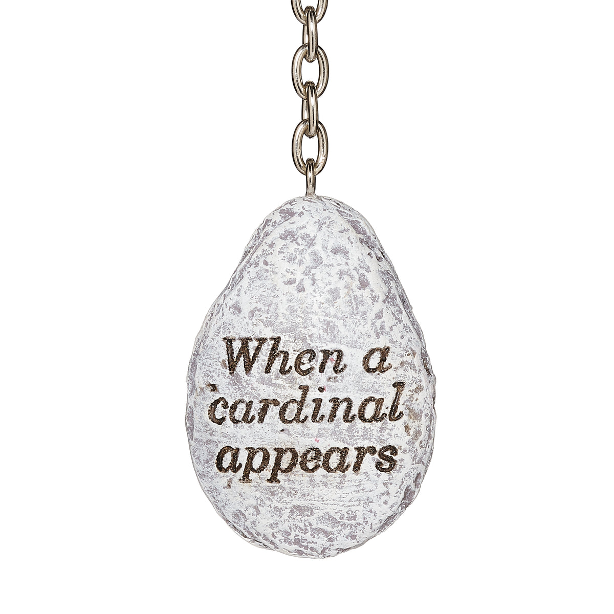 Close-up of windchime charm inscribed with "When a cardinal appears"
