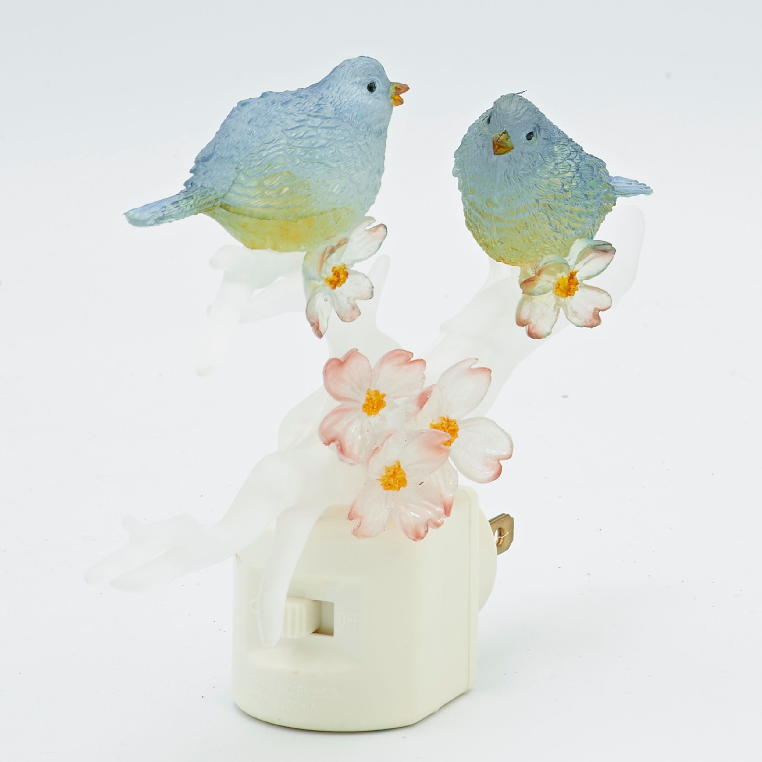 Decorative figurine of two birds on flowers with a white base