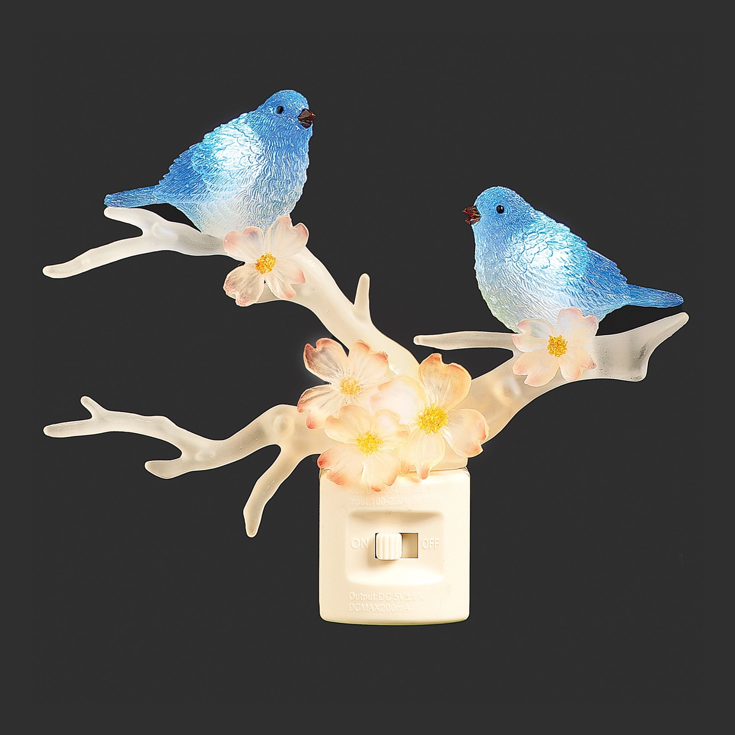 Decorative night light with blue birds on a branch and flowers.