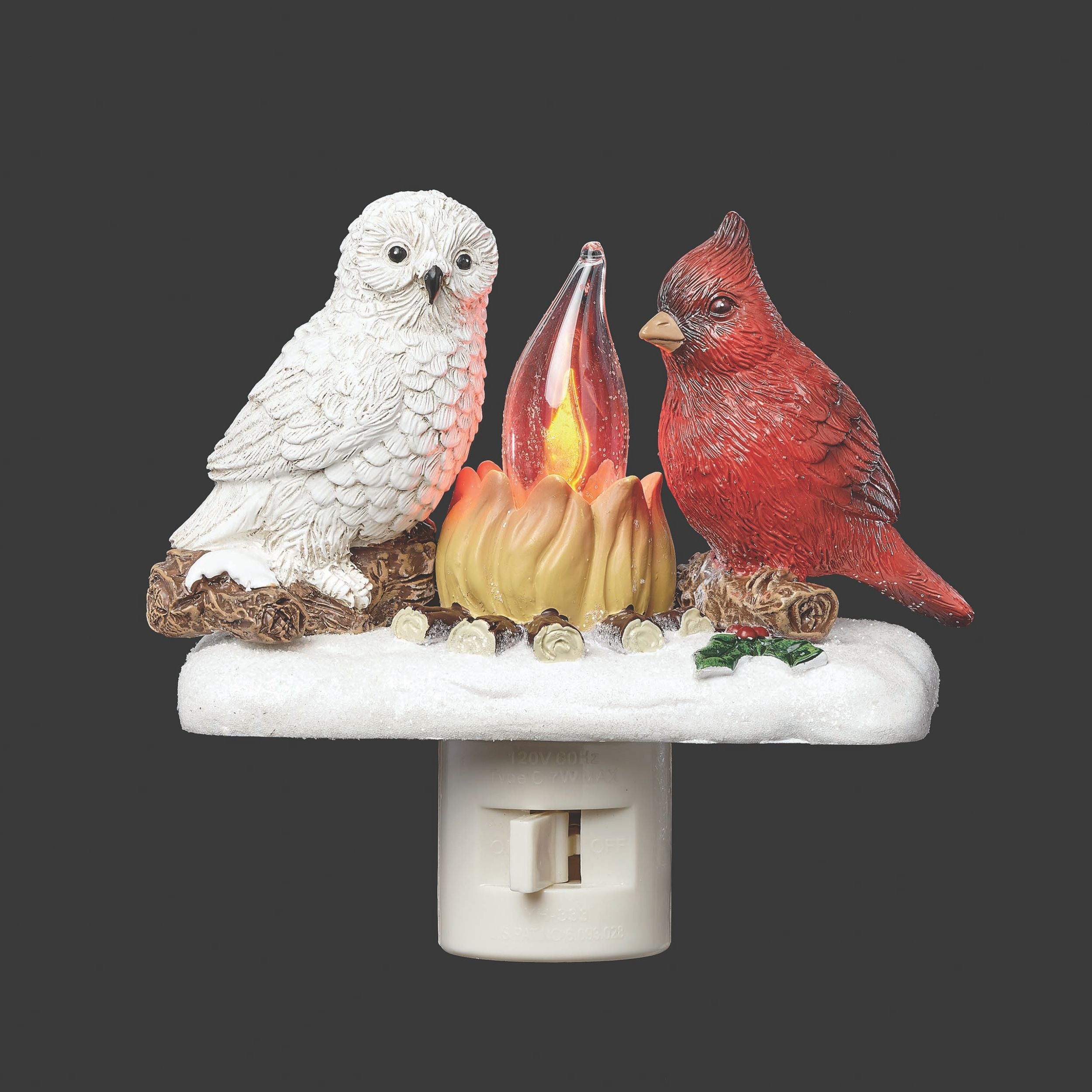 Decorative night light with an owl, cardinal, and candle design on a dark background