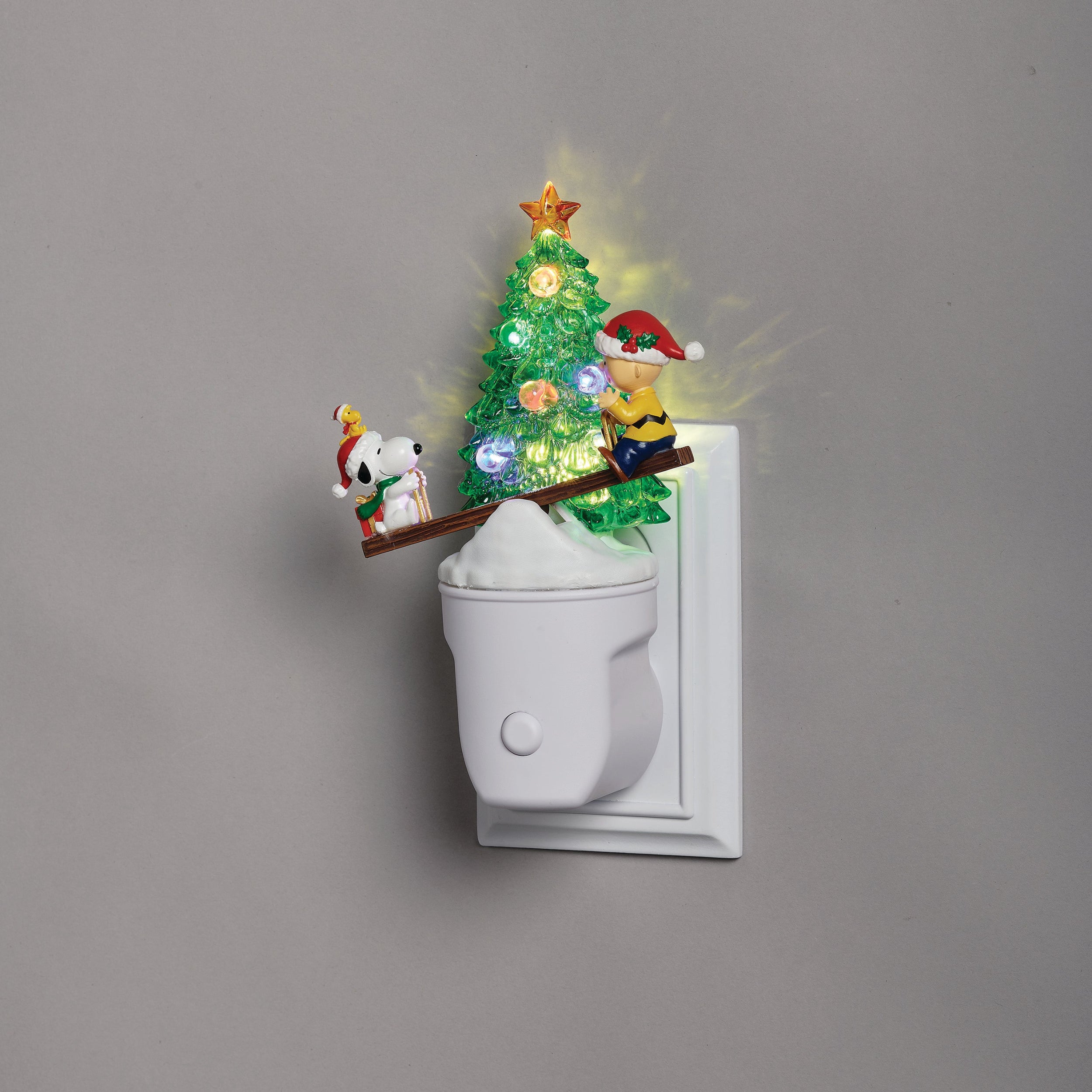 Decorative night light with a Christmas tree and cartoon characters on a gray background