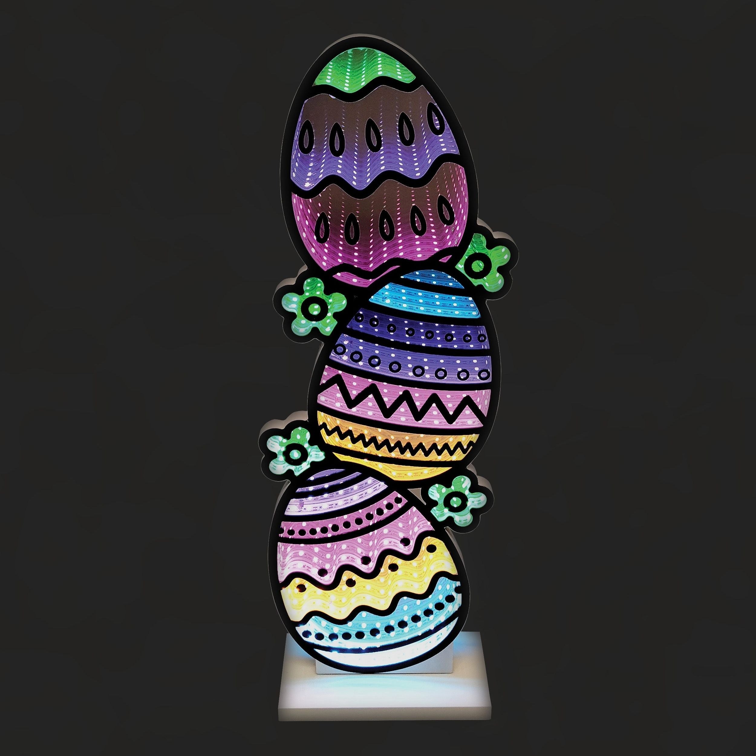 Colorful Easter egg-shaped LED light on a black background