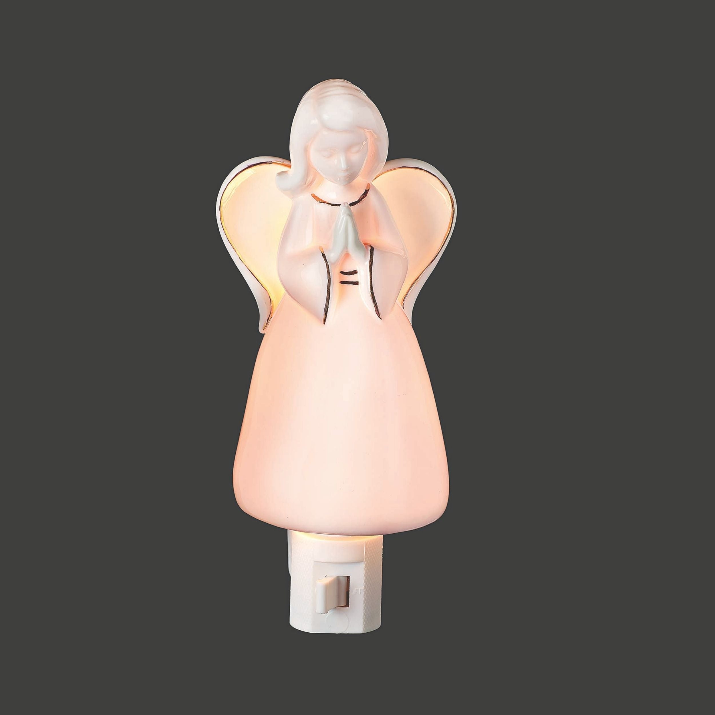 Angel-shaped night light on a dark background