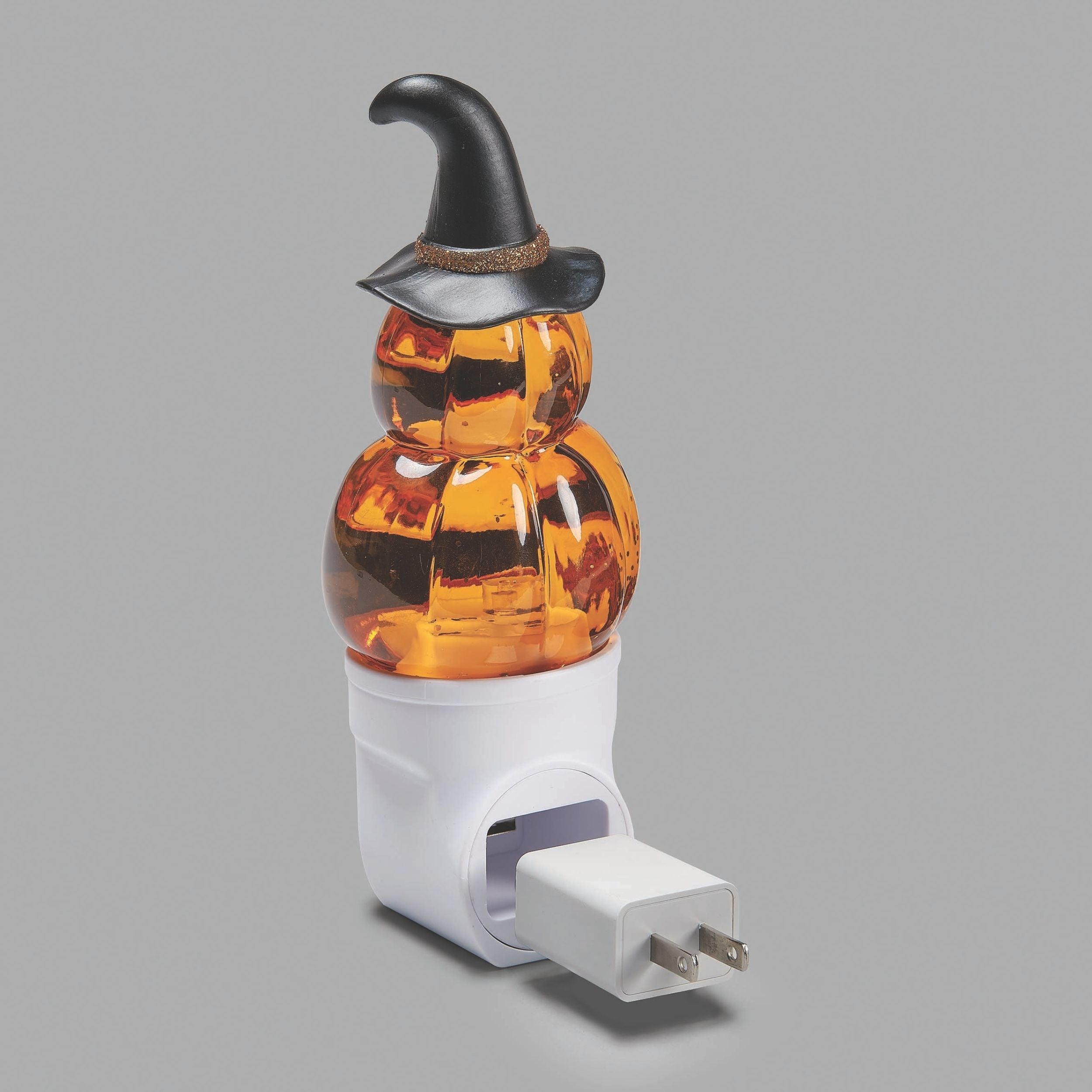 Halloween-themed night light with a pumpkin design and witch hat on a gray background