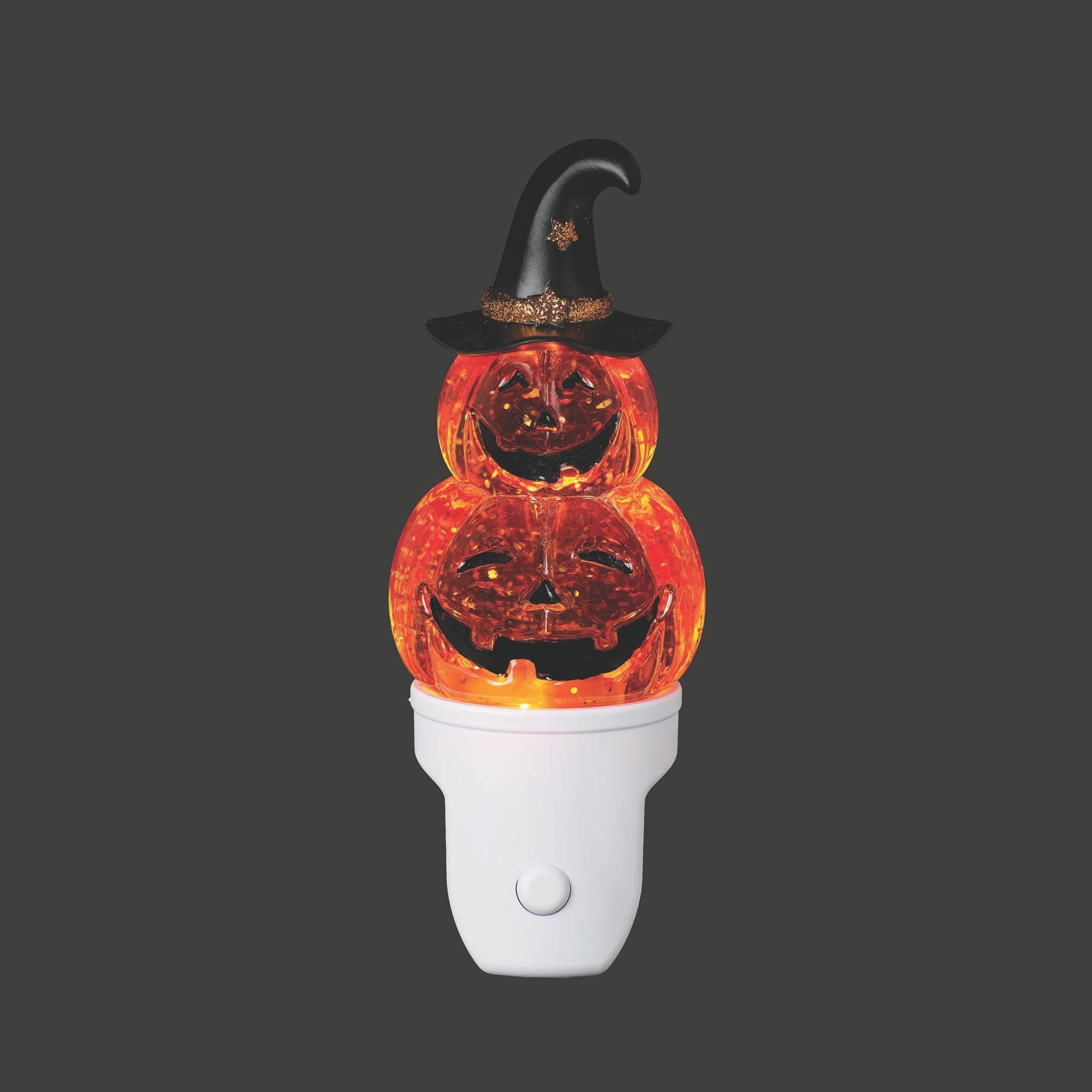 Halloween night light with two jack-o'-lantern faces and a witch hat on a dark background.