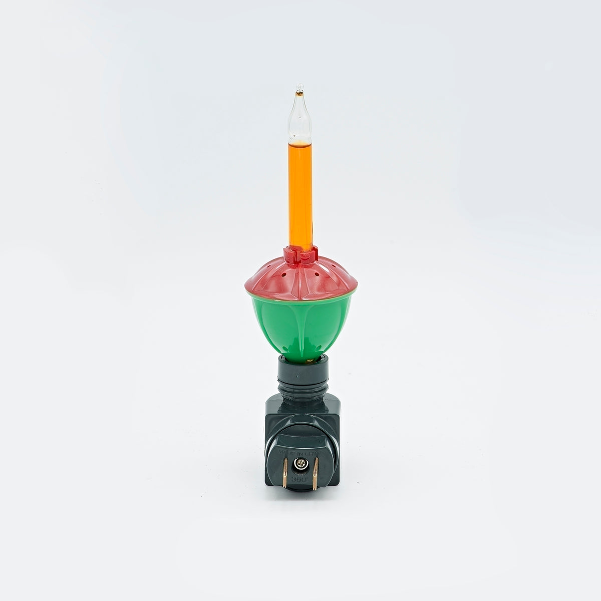 Rear view of Roman Lights Classic Christmas bubble night-light showing two plug prongs, a green body, red cap, and clear tube filled with orange liquid.
