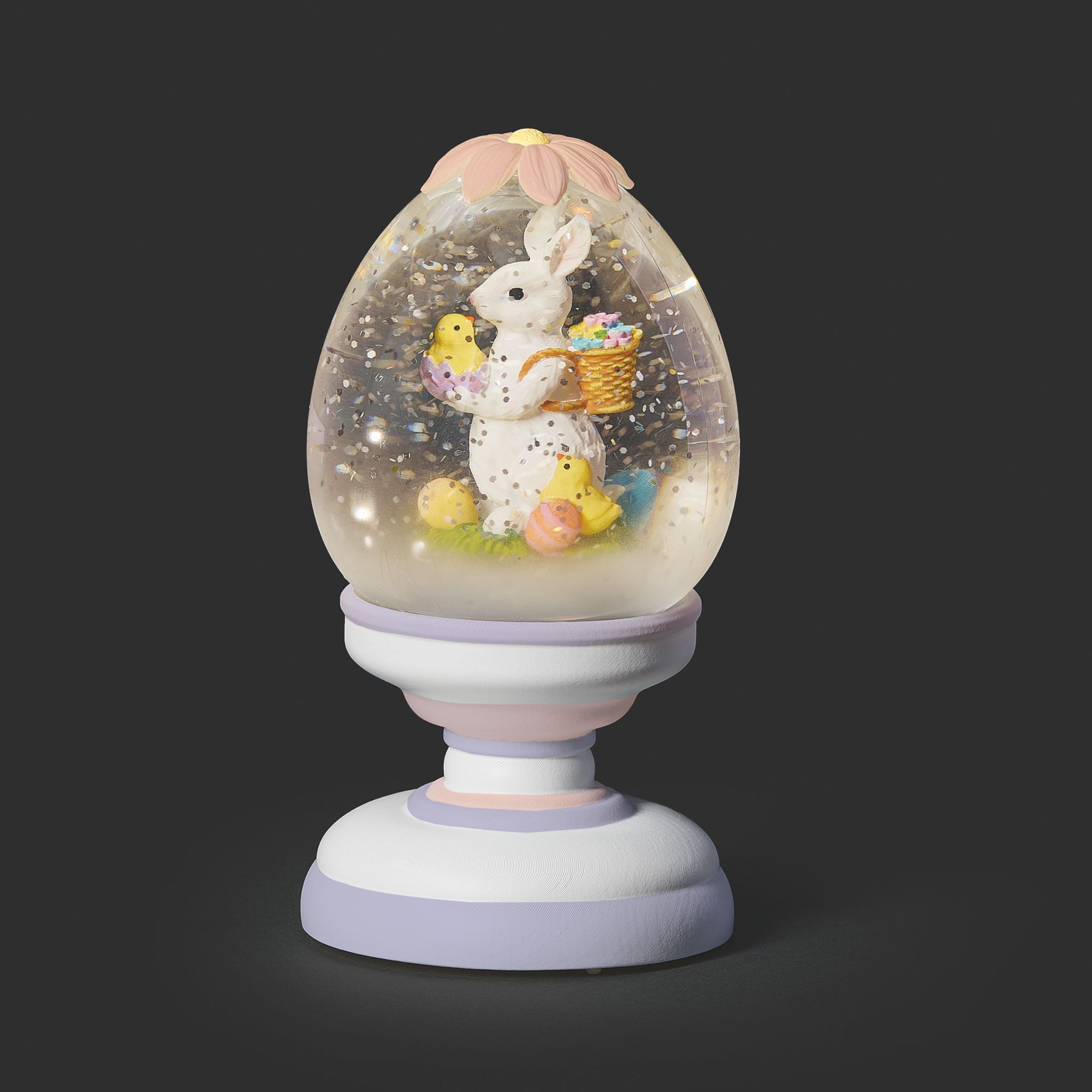 Decorative snow globe with a bunny and chicks on a dark background