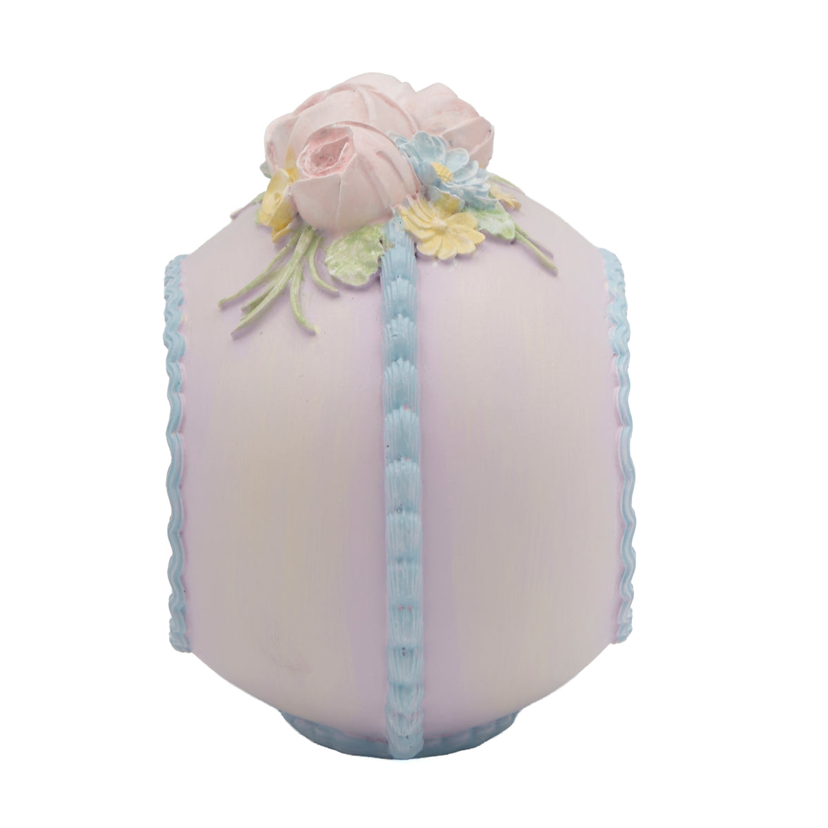 Side view of pastel Easter sugar egg decoration with floral and ribbon details