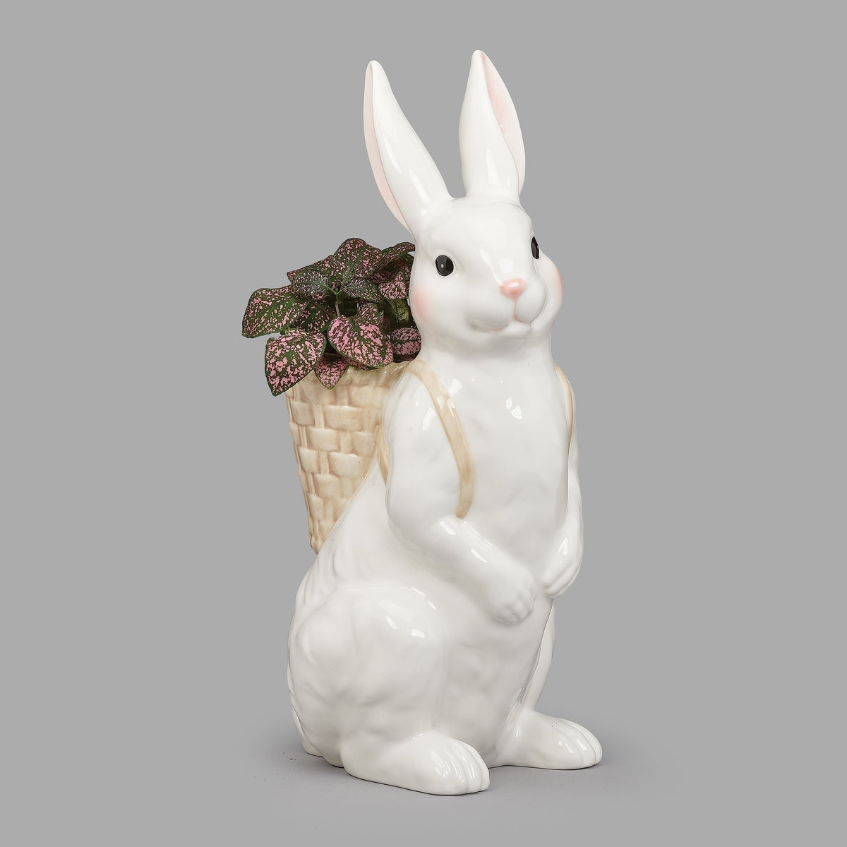 White ceramic Easter bunny backpack planter with woven basket and flowers
