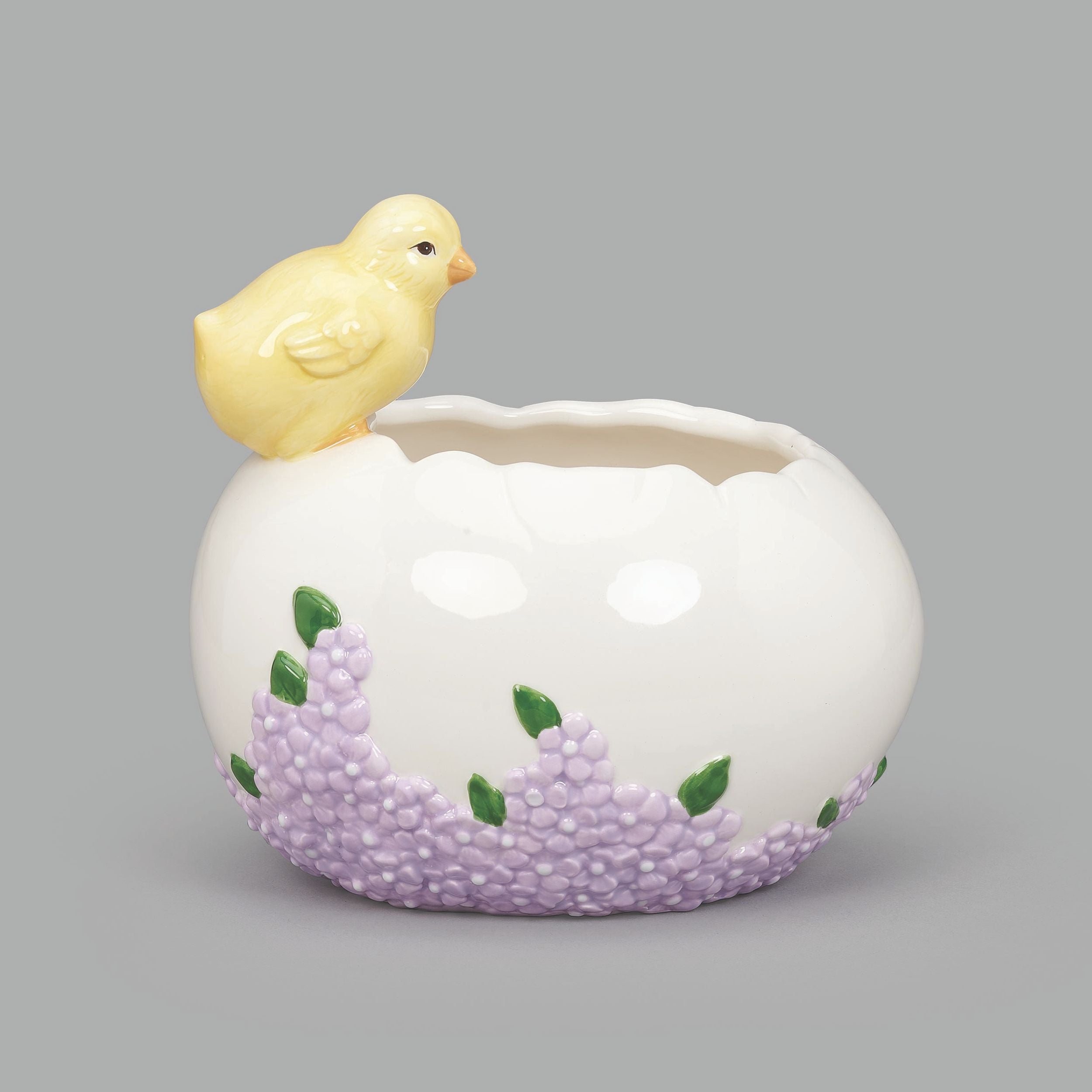 Ceramic planter with a yellow chick on top against a gray background