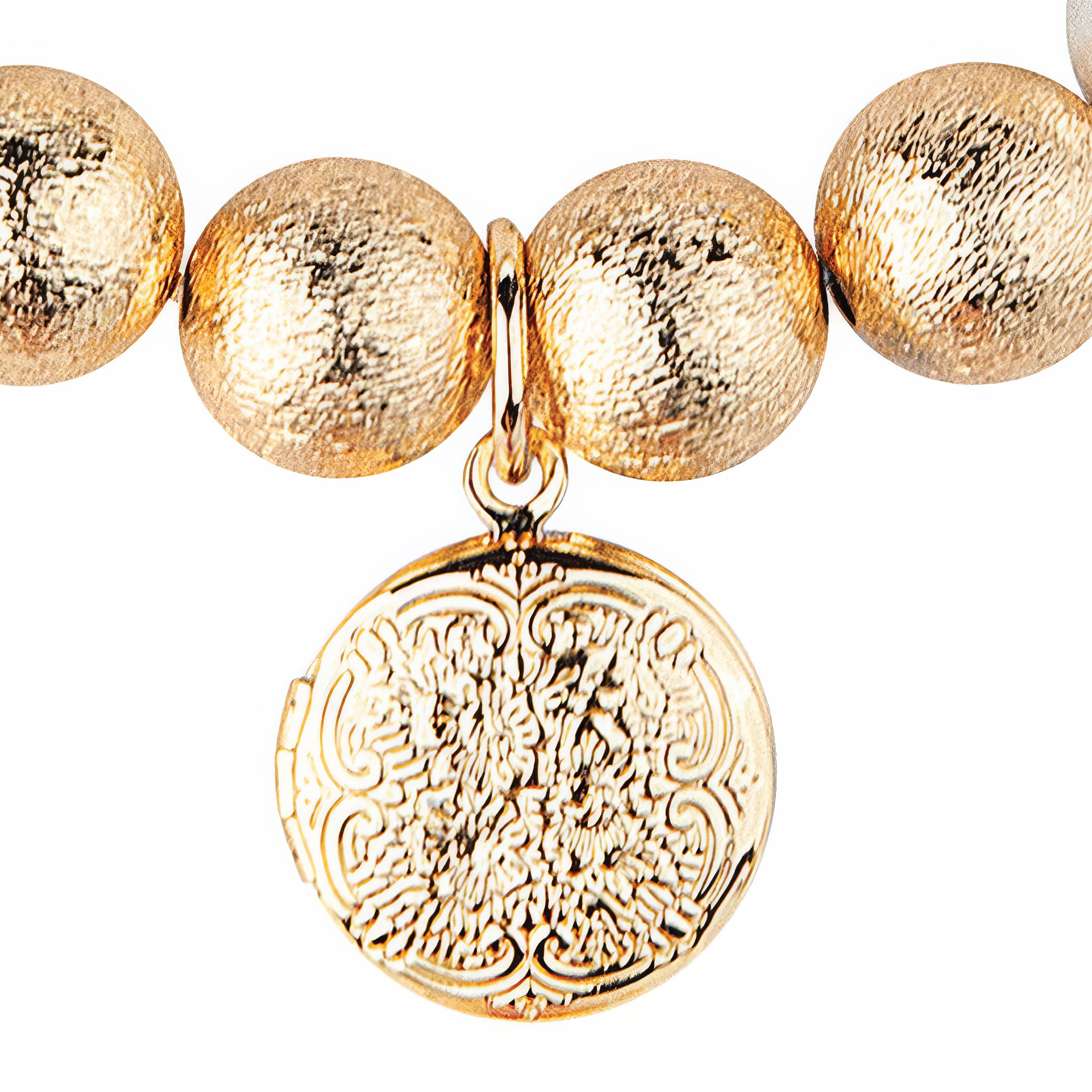 Gold beaded bracelet with a detailed gold charm on a white background