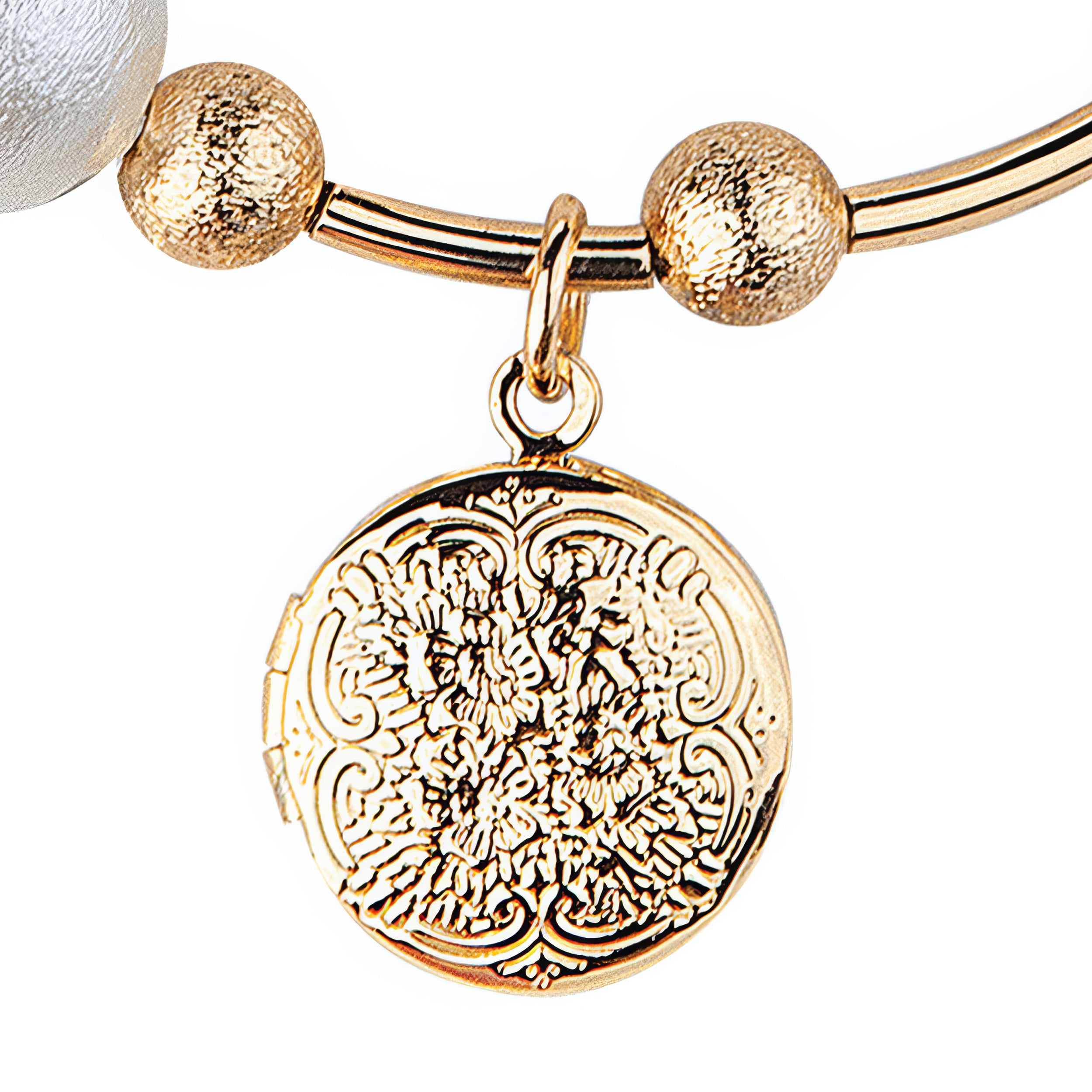 Gold bracelet with a detailed round pendant on a white background