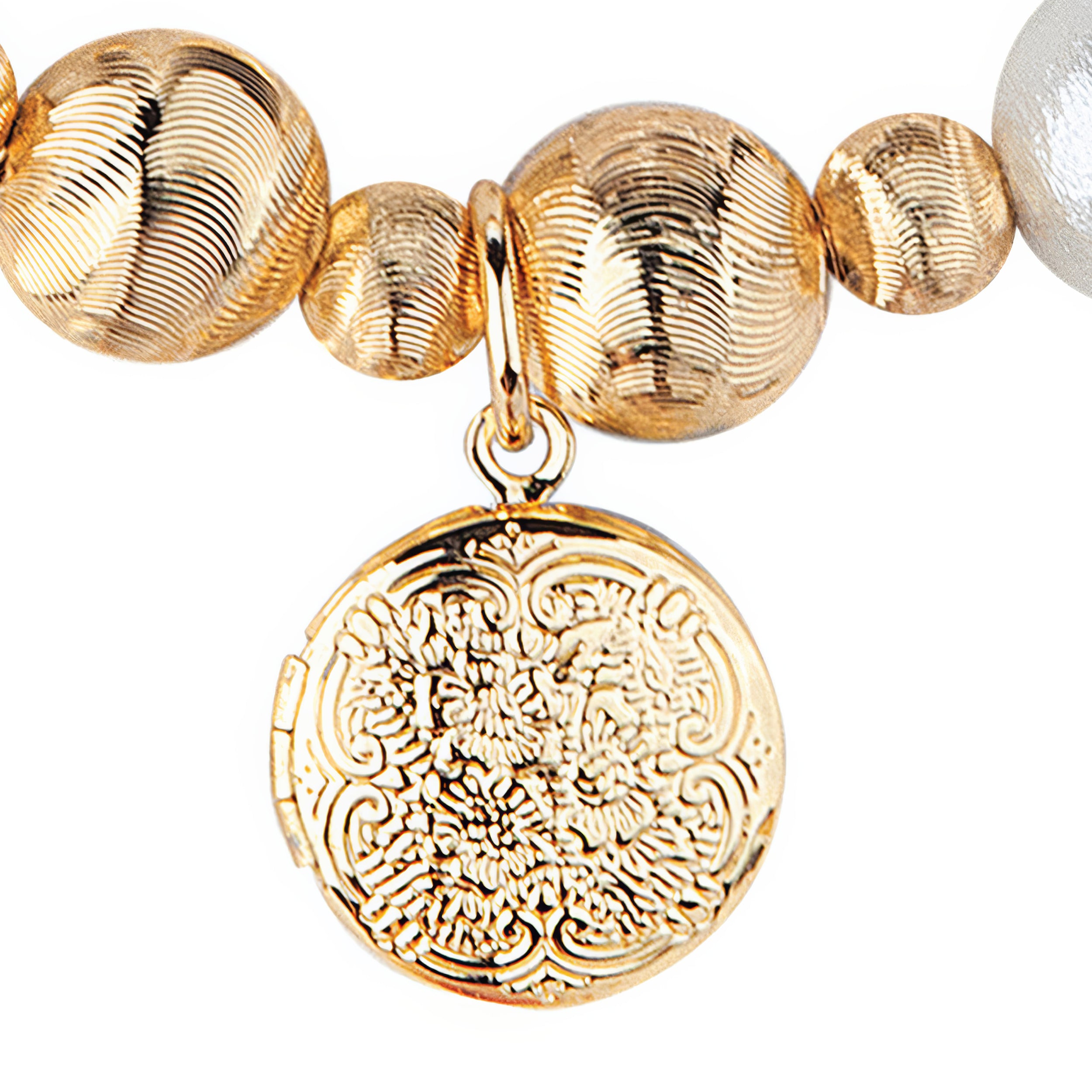 Gold beaded bracelet with a detailed gold charm on a white background