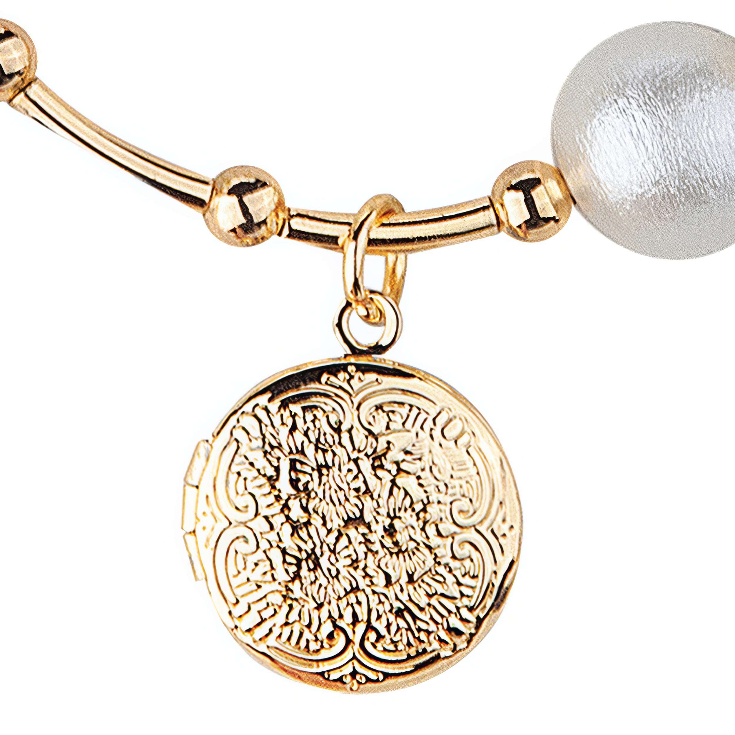 Gold bracelet with a decorative charm and pearl bead on a white background