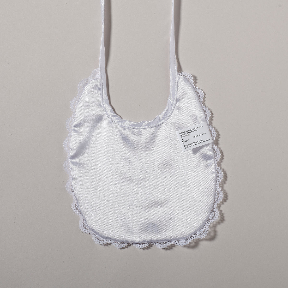 Alternate front view of Baptism Bib with Elegant Cross & Lace highlighting the satin fabric, cross embroidery, and decorative lace border