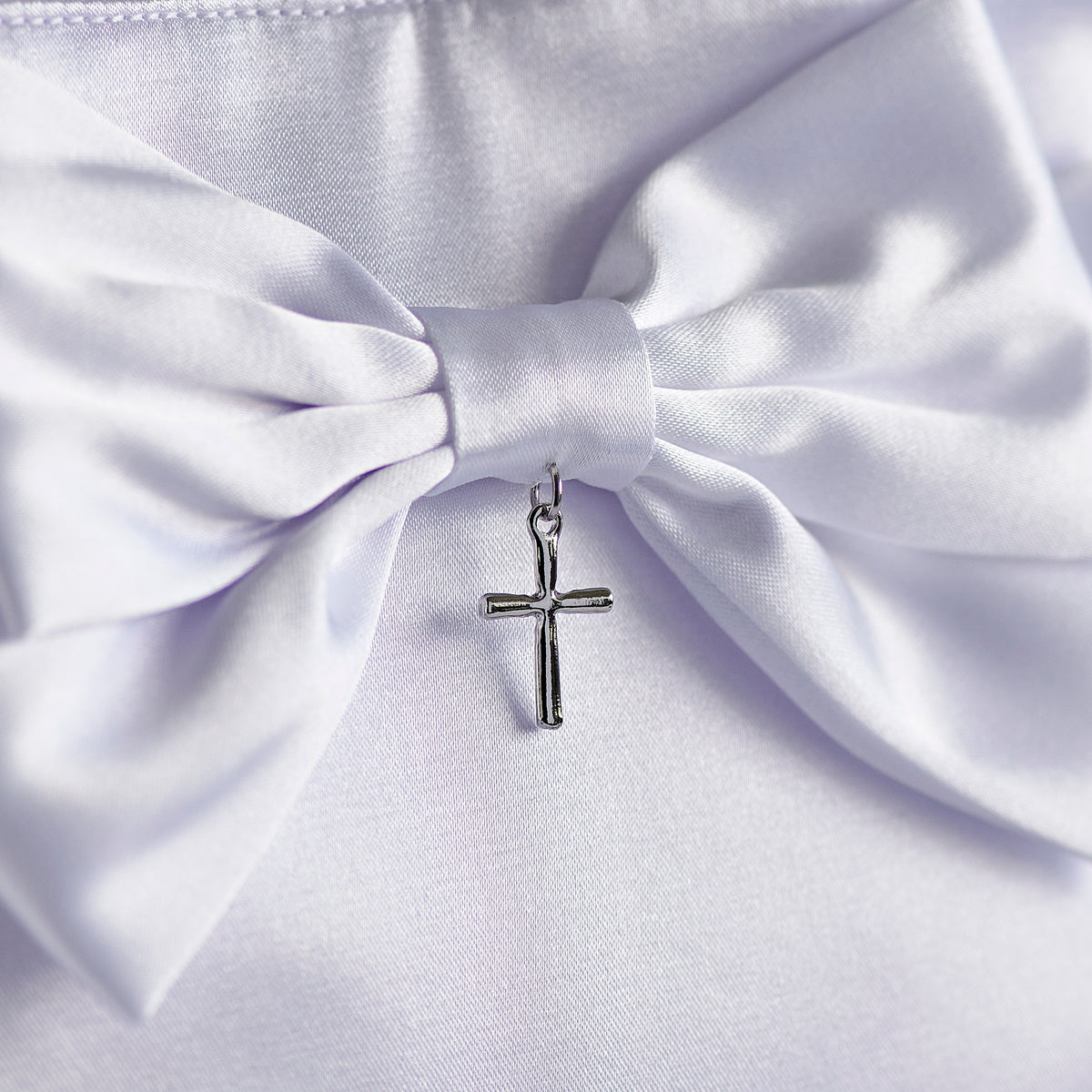 Close-up of Girl's First Communion purse showing the large white satin bow and small silver-tone cross charm