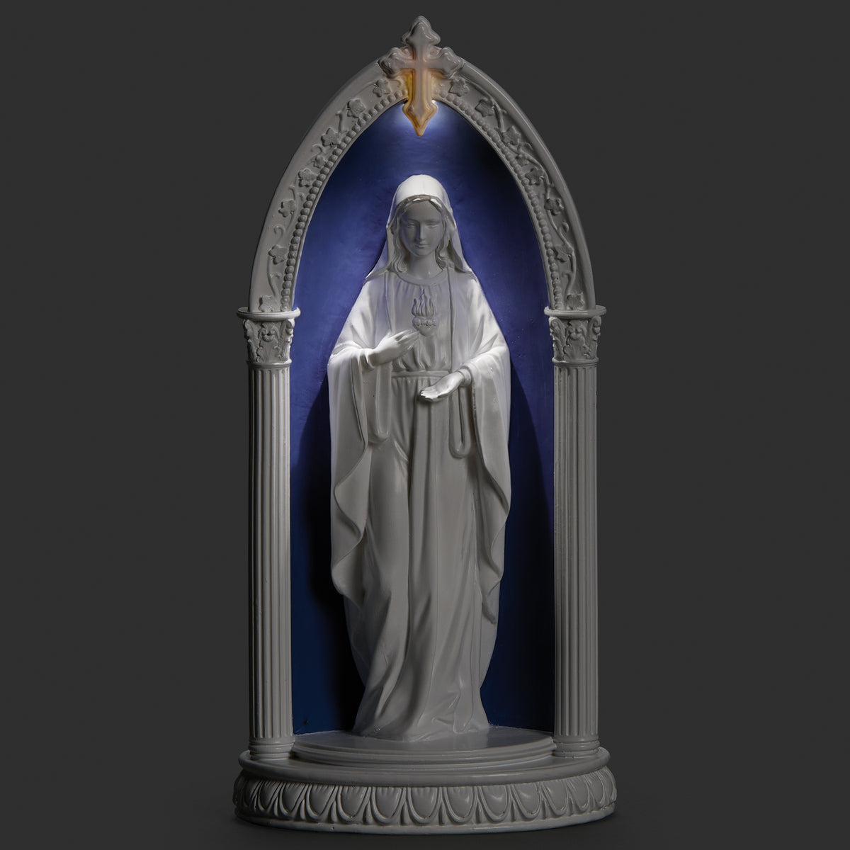 Lighted view of Immaculate Heart of Mary in Arch plaque glowing softly within the blue Della Robbia-style arch
