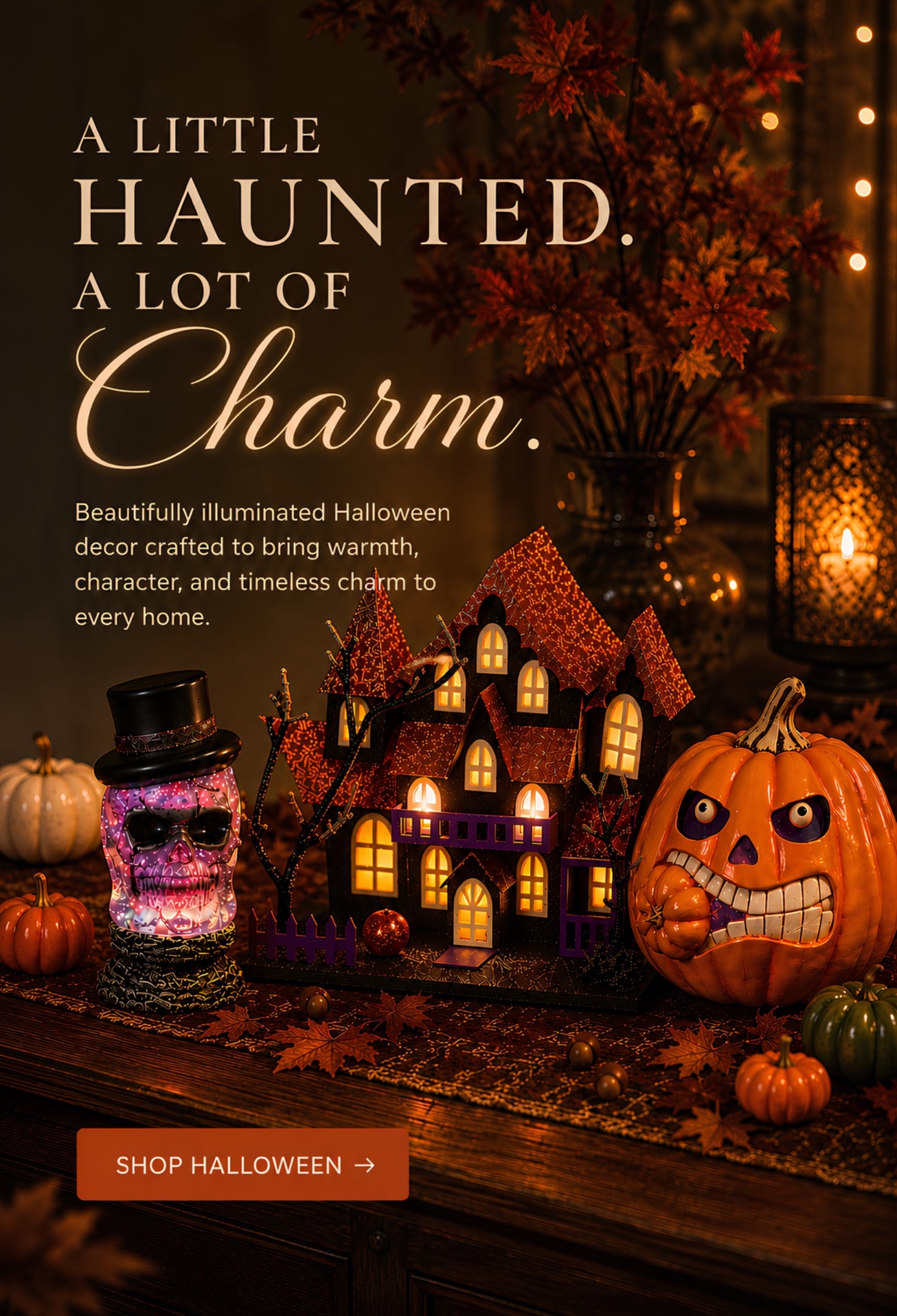 Halloween-themed promotional scene with a carved jack-o'-lantern, a haunted house decoration, candles, and a small decorative jar on a wooden surface. Large text reads 'A LITTLE HAUNTED. A LOT OF CHARM' with a shop halloween button.