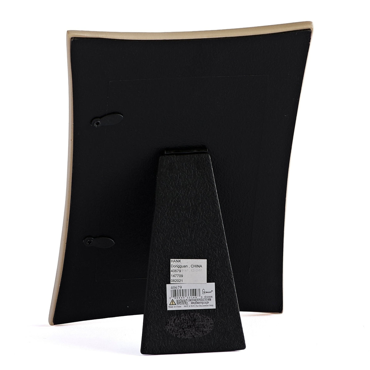 Back view of First Communion Gold Crucifix & Curved Edge Picture Frame showing the dark curved backing and fold-out easel stand
