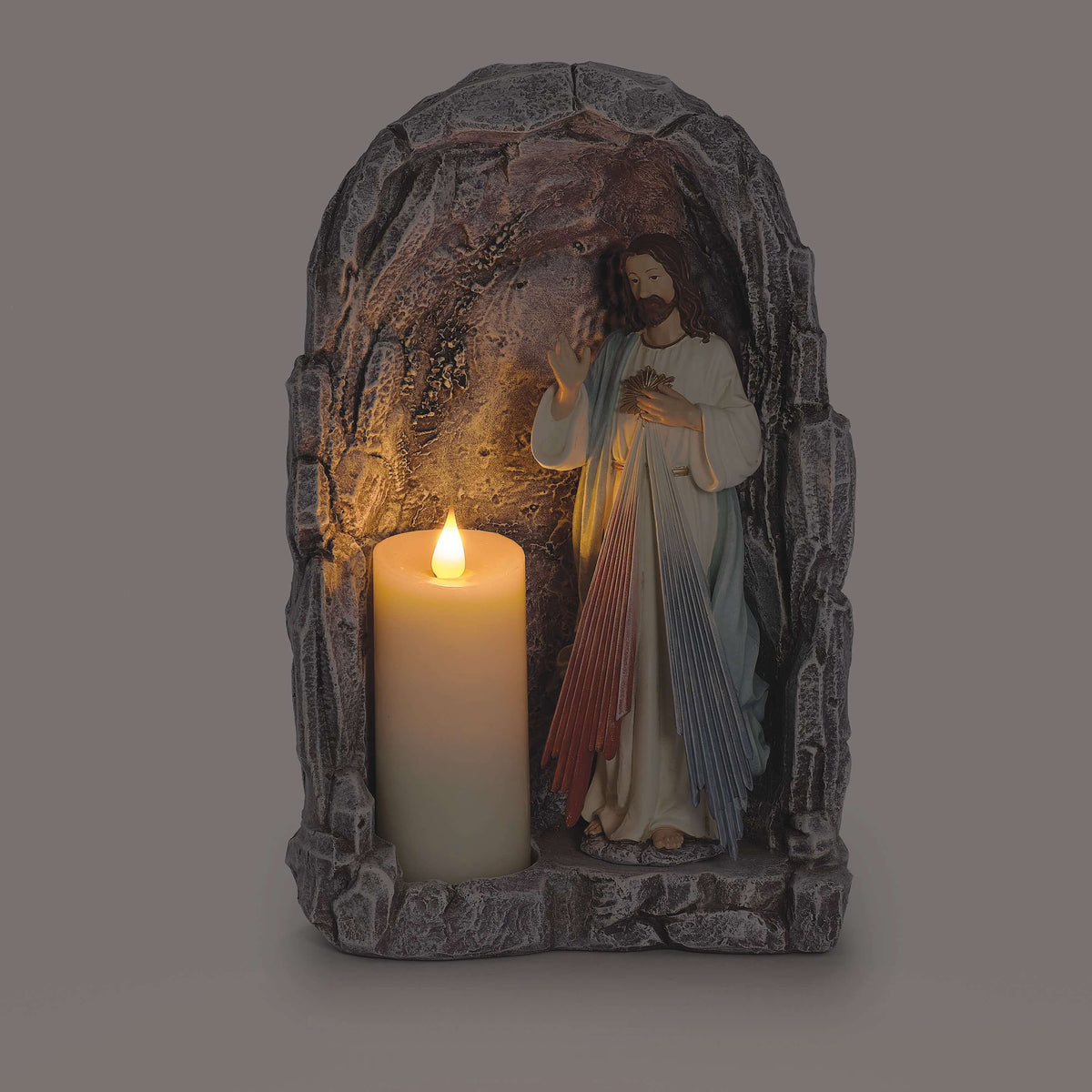 Divine Mercy Tabletop Grotto with candle illuminated inside stone-look arch