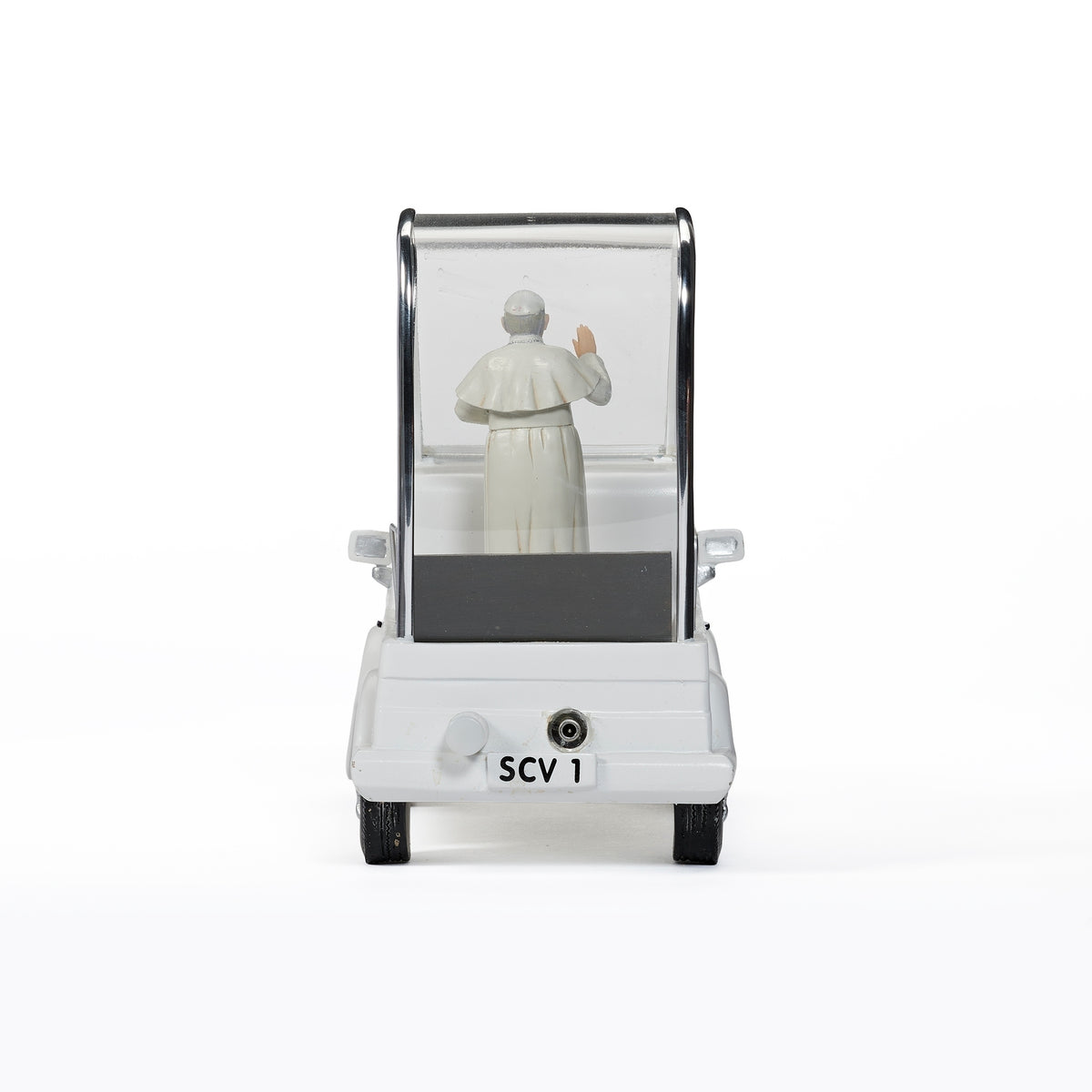 Rear view of Musical Pope Mobile showing the Pope figure inside the white vehicle and open rear platform