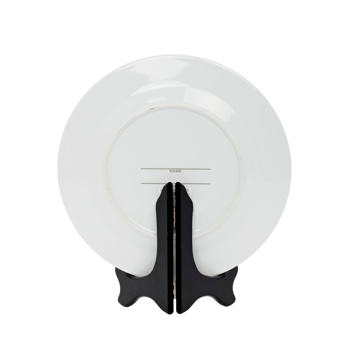 Rear view of anniversary plate showing its plain white back and supporting black stand.
